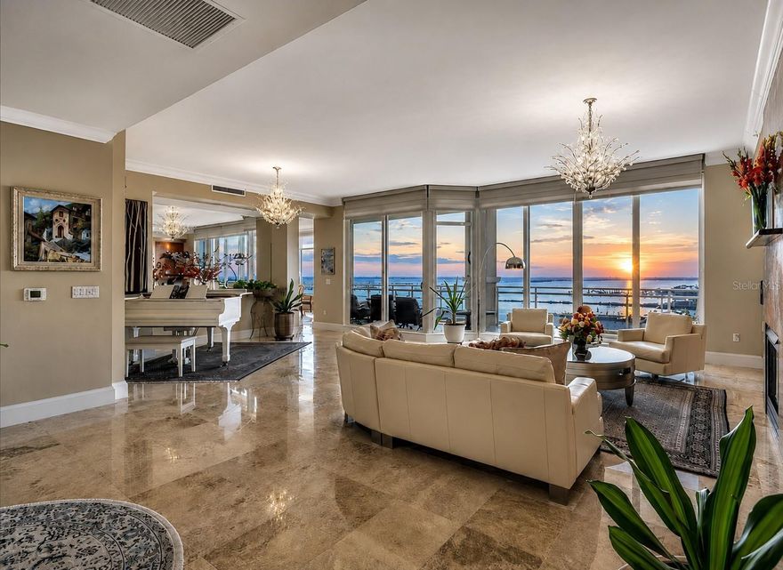 PENTHOUSE WITH PANORAMIC WATER VIEWS, SUNSETS & PRIVATE ELEVATOR IN BEL MARE!

Experience expansive water views and unforgettable sunsets from this 15TH FLOOR PRIVATE ELEVATOR RESIDENCE in Bel Mare at Riviera Dunes. Positioned high above the Manatee River, the views stretch west toward ANNA MARIA ISLAND AND THE GULF, creating a truly elevated coastal setting.

This rarely available PENTHOUSE OPPORTUNITY offers a thoughtfully designed SPLIT FLOORPLAN WITH 3 BEDROOMS PLUS OFFICE/DEN, soaring ceilings, and walls of glass that frame the surrounding water and skyline. THREE PRIVATE BALCONIES provide multiple vantage points, blending indoor and outdoor living.

The great room features CUSTOM BUILT-IN CABINETRY and a modern GAS FIREPLACE with STUNNING VEINED BLACK GRANITE SURROUND, creating a refined focal point for both everyday living and entertaining.

The GOURMET KITCHEN has been redesigned with a single-level quartz island, SUB-ZERO REFRIGERATION, six-burner gas cooktop, new convection double wall ovens, BOSCH PANELED DISHWASHER, industrial-grade hood, and quartz undermount sink. The open layout allows for seamless entertaining while maintaining uninterrupted views.

The PRIMARY SUITE is positioned to capture the waterfront, offering a private retreat with a wet bar, beverage refrigeration, TWO WALK-IN CLOSETS, and a spa-style bath with soaking tub and walk-in shower. An adjacent flex space opens to a private balcony. Two additional guest suites provide comfort and privacy with ideal separation.

A standout feature is the PRIVATE TWO-CAR GARAGE, along with an additional UNDER-BUILDING PARKING SPACE—an uncommon and highly desirable combination in this community.

Additional enhancements include Hunter Douglas energy-efficient shades, UV/heat-control window film, extensive crown molding, South American hardwood flooring, travertine flooring, THREE TRANE VARIABLE-SPEED HVAC SYSTEMS (2021), Halo air purification system, Rheem water heater (2023), and whole-house Pelican water filtration with reverse osmosis.

Residents of BEL MARE enjoy a RESORT-STYLE LIFESTYLE with multiple pools, fitness center, theater, billiards, social rooms, guest suites, and access to tennis and pickleball courts. Located adjacent to the RIVIERA DUNES MARINA, residents enjoy deep-water boating access to the Gulf.

Ownership also includes access to the private BEACH CLUB, featuring a lap pool, resort-style pool, putting green, pickleball, bocce, volleyball, and social gathering spaces, along with a fitness center, classes, and on-site café.

Located in PALMETTO, this property offers strong value compared to similar waterfront residences in Sarasota, St. Petersburg, and Tampa, while remaining close to beaches, dining, arts, golf, and SRQ, TPA, AND PIE AIRPORTS.

This is a rare opportunity to own a WELL-APPOINTED PENTHOUSE WITH EXPANSIVE WATER VIEWS, FUNCTIONAL LAYOUT, AND RESORT-LEVEL AMENITIES along Florida’s Gulf Coast.