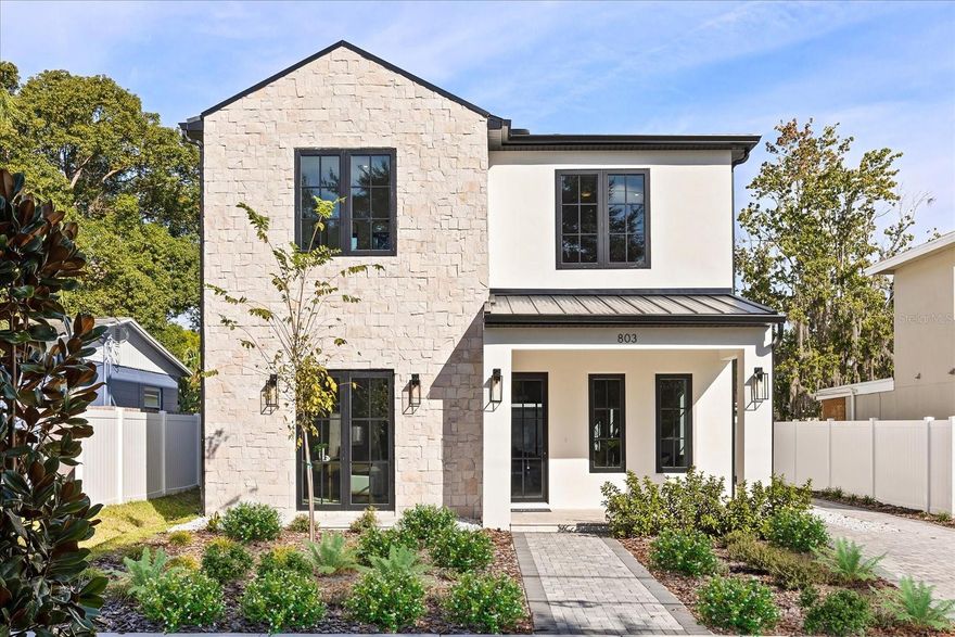 A newly constructed luxury home in the heart of College Park, this property blends modern craftsmanship with the classic charm of one of Orlando's most beloved neighborhoods. The main level unfolds with an effortless sense of openness, where the living room, dining room, and family room flow seamlessly around a chef's kitchen appointed with stone counters, a designer range hood, and a suite of built-in appliances including a wine refrigerator. A private bedroom with a full bath on this level offers ideal flexibility for guests or a dedicated workspace.

The second floor is designed for comfort and privacy, beginning with a serene primary suite featuring a generous walk-in closet and a spa inspired bath.Three additional bedrooms provide abundant space for family and visitors, while a loft and an upstairs laundry room add everyday convenience to the thoughtful layout. Throughout the home, engineered hardwood and porcelain tile floors combine durability with beauty, and features such as zoned climate control, custom accents, and ample storage showcase the quality of construction.

Outdoors, the lifestyle continues with a covered living area, an outdoor kitchen, and a landscaped yard ideal for quiet evenings or weekend gatherings. A long driveway leads to a rare detached garage that adds both convenience and private covered parking. Sidewalk lined streets connect you to the energy of College Park, where local dining, boutique shopping, parks, and the upcoming Packing District enrich every day.

Move in ready and meticulously designed, this luxury home offers a refined way of living in a location that brings the best of Orlando to your doorstep