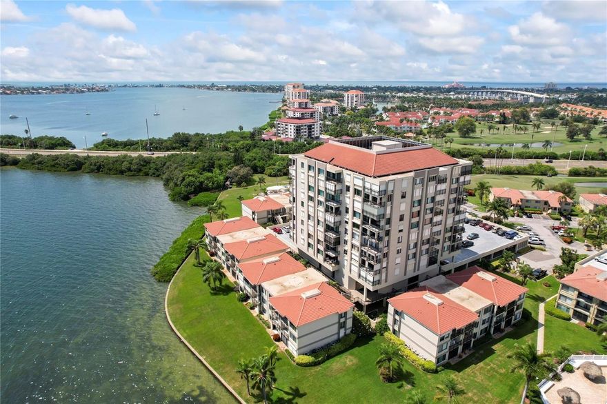 Welcome to the Isla del Sol, home of Palma del Mar, nestled in the middle of Boca Ciega Bay! This 2 BED 2 BATH condo is just minutes away from the beaches that consistently rank among the best in the world and is the BEST PRICED unit in the building! As soon as you enter the unit, you are immediately greeted with a spacious OPEN FLOOR PLAN and tons of natural light. The Kitchen is spacious and has with granite counter tops, tons of cabinet space, and a breakfast bar for additional guest seating. Both bedrooms are at the opposite end of the unit from each other for added privacy and have an EN-SUITE BATH and large WALK-IN CLOSETS. Primary bath was RECENTLY RENOVATED. NEW A/C (2024) and NEW ROOF! Full size washer dryer (2024) conveniently located inside of the unit. Sip coffee and enjoy the Florida weather from the spacious patio. This unit is also equipped with hurricane shutters! Assigned parking spot #147 accompanies this unit and guest parking is available nearby. COMMUNITY AMENITIES include a Recreation Room, Covered Reserved Parking, a Geo-Thermal Heated Pool/Spa, kayak storage with launch, and a Private Fishing Pier! PET FRIENDLY: community allows for 2 pets per unit (up to 25lbs each). HOA FEE INCLUDES basic cable & internet. Enjoy all this lovely island has to offer by joining the Isla Del Sol Yacht & Country Club and play the 18 hole championship golf course and tennis courts (for a separate fee). CONVENIENTLY LOCATED minutes from St. Pete Beach, Downtown St Pete, Ft DeSoto Park, shopping, restaurants, I 275 and Tampa International Airport. Maintenance free living at its finest!