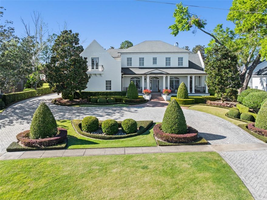 Welcome to this charming stately lakefront estate, a true gem straight from the pages of Southern Living—just minutes from Winter Park and the finest dining in Maitland, all on the serene shores of Lake Sybelia. From the moment you arrive, the large, inviting porch with it's charming swing beckons you into a home flooded with natural light and warm wood floors and a thoughtfully designed layout.

The heart of this home is the expansive kitchen, seamlessly flowing into the family room and offering French doors that lead to a picturesque backyard. The downstairs primary suite provides a luxurious retreat, featuring large walk-in closets and a beautifully remodeled bathroom with a soaking tub and dual vanities.

A private guest suite is conveniently located off the family room, offering its own entrance and separation from the rest of the home. Upstairs, you'll discover three generously-sized secondary bedrooms, a dedicated theater room, a private study, and a spacious bonus room complete with custom built-ins—perfect for play, work, or relaxation.  Move right in as this home has not only been freshly repainted but all bathrooms have been remodeled and refreshed. 

Step outside to your personal private oasis, with no rear neighbors, where a newly remodeled pool with a sun shelf, stunning decking, and fire bowls set the perfect ambiance for both relaxation and entertaining. The lush side yard enhances the home's charm, while the boat dock provides the perfect spot to watch breathtaking sunsets or enjoy water sports on Lake Sybelia.

This exceptional property offers the perfect blend of comfort, style, and lakeside living. Don’t miss the opportunity to make it your own!