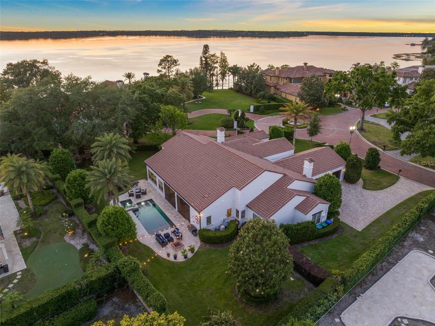 One or more photo(s) has been virtually staged. Where luxury meets location! Rarely does a home become available in the hidden gem of gated Bentley Park - a community of just 16 distinguished residences near coveted Bay Hill. This nearly 5,200-ft² architectural masterpiece boasts five bedrooms, four of which are ensuite, including a private, attached in-law suite, ensuring a perfect blend of grand entertaining spaces and private retreats. Step through the charming courtyard entrance and your are greeted by a dramatic foyer featuring striking herringbone wood ceilings and custom lighting accentuating every detail. The soaring great room and gourmet kitchen, are highlighted by an expansive wall of French doors, effortlessly inviting the outdoors in for a true luxury, Florida living experience. In this spacious, custom kitchen you will find Thermador appliances, a six burner gas cooktop with pot filler, expansive island and a walk-in pantry, making this space a chef's dream. The French doors lead you to an exceptional covered and screened living area that seamlessly connects to a spectacular backyard oasis. Set on a beautifully landscaped .63-acre lot, this property offers views of Lake Tibet of the famed Butler Chain, from your front and side yards! Imagine relaxing by your sparkling pool and spa, framed by stone decking and complemented by a fully equipped summer kitchen, complete with grill, sink, and fridge. A dedicated pool bath ensures comfort and convenience during every summer gathering. Designed with a split-plan layout, the private primary suite provides a serene sanctuary with its own secluded view of the lake, while the primary bath boasts custom cabinetry, luxurious granite accents and travertine flooring, with an elegance that exudes sophistication. The attached in-law suite is equally impressive, featuring its own living room, wet bar area, bedroom, and private bathroom - ideal for extended family or guests. The double door entrance to the fifth bedroom makes it ideal for a large playroom or office, while the flexibility of your air conditioned Florida room offers stunning views of the gorgeous grounds and lanai. Living in Bentley Park provides amenities exclusive only to residents—such as a private playground, tennis courts and a fishing pier on Lake Tibet, where you can enjoy spectacular views of Disney and Universal fireworks! And with Arnold Palmer's Bay Hill Club and Lodge only a mile away, and the shops and dining of Restaurant Row just around the corner, location and luxury meet seamlessly at this stunning residence. Two newer ACs (2023 and 2024) also speak to the quality of maintenance and care of this stunning estate home. Embrace the pinnacle of refined living at 9224 Bentley Park Circle, where timeless elegance blends with modern comforts in a setting designed to captivate and inspire. Schedule your viewing of this immaculate estate today.