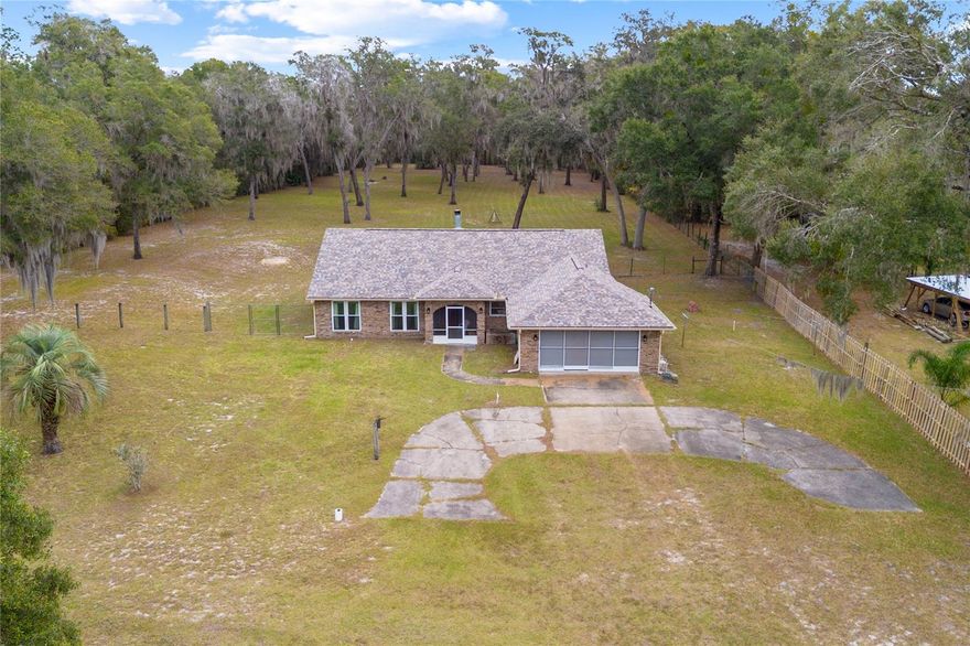 This 2.50 acre property offers mature oak trees, privacy with room to expand, and no HOA. A solid 3-bedroom, 2-bath brick home has a practical layout with ongoing updates already started. From the front entry, you step into an open living area featuring a wood-burning fireplace and direct flow into the newly renovated kitchen. The kitchen includes quartz counters, an island, and two pantries, creating plenty of workspace and storage.
Down the hall, the primary bedroom includes a fully remodeled en suite with an oversized walk-in shower, dual showerheads with separate controls, and floor-to-ceiling tile. The additional bathroom has also been updated. Every room has oversized windows, bringing in natural light throughout the home. A bright Florida room on the side of the house offers additional living space with large windows overlooking the property.
Buyers can continue the upgrades and add custom touches—such as a closet system in the primary closet—to make the home their own. The property includes two wells (one for the home, one for irrigation). Roof replaced in 2024.
Owners are also selling the connected 2-bedroom home at 420 Glenwood Rd (MLS V4946063). The two parcels share a legal easement that provides access between the properties, creating a great opportunity for buyers needing two nearby homes or multigenerational options.
Located minutes from shopping centers, restaurants, grocery stores, and award winning Downtown DeLand and Stetson University.