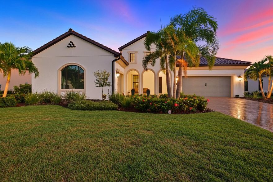 This modern Mediterranean custom home from builder Neal Signature exudes luxury & elegance every step of the way! Meticulously cared for, this beautiful 4 bedroom, 3.5 bath pool home showcases the Positano floorplan and is LOADED with upgrades, sitting on a beautifully landscaped lot with no rear neighbors. The curb appeal is undeniable, with its Italian-inspired elevation, ceramic barrel tile roof, pavered driveway, & inviting front porch that sets the stage for the elegance inside. Step through the entryway into a dramatic, color-rich foyer that opens to a bright and airy Great Room, highlighted by soaring tray ceilings with shiplap detail, walls of triple transom-topped windows, & stunning engineered wood floors that flow seamlessly throughout the main living areas. In-ceiling speakers in the Great Room elevate movie night into a true cinematic experience. Just off the Great Room, a versatile den offers the perfect flex space, ideal for a home office, media room, or home gym. Overlooking the Great Room is your large gourmet designer kitchen, featuring stacked cabinets, custom vent hood, quartz countertops with a waterfall island, built-in stainless appliances incl. natural gas cooktop, double wall oven, a built-in fridge, & an enormous walk-in pantry w/ventilated wood shelving. Adjacent to the kitchen, the spacious dining room effortlessly accommodates both everyday dining and upscale gatherings. Impact sliders from the dining room lead you to the crown jewel of the home...your GORGEOUS, oversized screened-in lanai and heated saltwater smart pool w/sunshelf. The custom outdoor kitchen is an entertainer's dream & includes Perlick fridge, Delta Heat teppanyaki flat top grill, & sink. Enjoy serene, southern-facing views, a backdrop of tropical landscaping, & privacy hedging that transforms this space into a true backyard retreat. Back inside, the impressive oversized Primary Retreat delights with its tray ceiling, feature wall with custom wallpaper, & pendant accent lighting. Your Primary Bath includes extended vanity w/quartz counters, double sinks, walk-in shower w/floor to ceiling tile, marble shower floor, shower bench, & 2 separate large walk-in closets w/upgraded ventilated wood shelving. Two additional bedrooms are tucked at the front of the home with a shared hall bath, while a fourth bedroom serves as a private Guest Suite with its own walk-in closet & full en-suite bath w/walk-in shower. A stylish powder bath is conveniently located off the foyer for guests, & a spacious utility room beyond the kitchen offers built-in upper & lower cabinets, open shelving, & single bowl sink. Other notable features include: Impact windows on front of home; Custom designer lighting from Arhaus and Crate & Barrel; Custom window treatments; DC ceiling fans; Security system on windows & doors; Home automation control; Epoxy floors in garages; Insulated garage door panels & insulation above both garages; EV charging circuit in garage; Wi-Fi extenders; Generator port switch to use with portable generator; Landscaping lighting; Tankless gas water heater & more! Residents of the gated, maintenance-free Aria community enjoy world-class amenities including a resort-style pool, spa, fitness center, pickleball court, a vibrant clubhouse, scenic lakes, and an events lawn. Situated near downtown Venice, with shopping, dining & entertainment nearby, & only 15 minutes from Venice Beach, 8 minutes to Sarasota Memorial Hospital, and quick & easy access to I-75.