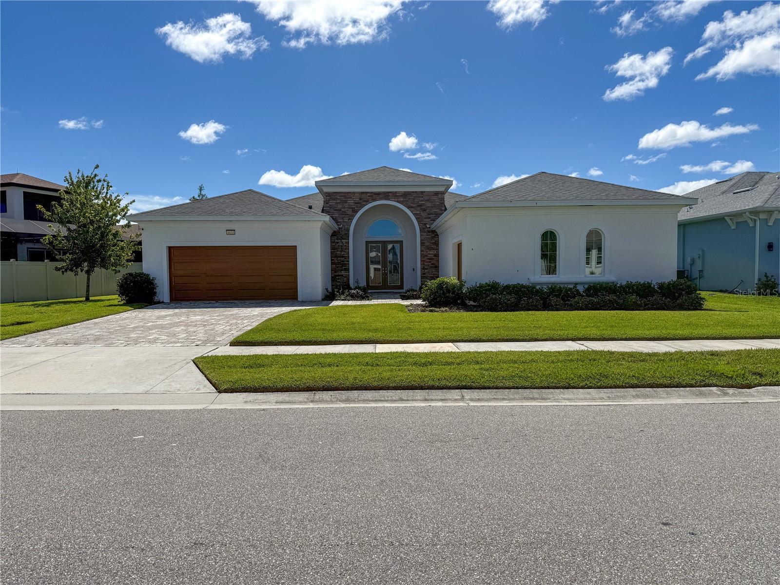 Welcome to 8833 Sanders Tree Loop, an exquisite 3-bedroom, 3-bathroom, 3-car garage home located in the sought-after Epperson community of Wesley Chapel. Built in 2023, this beautifully designed Biscayne Sabal I model sits on a spacious 10,236 sq ft lot and offers over 3,100 sq ft of open living space—perfect for both entertaining and everyday living. Step inside to discover a thoughtfully crafted layout featuring high ceilings, upgraded tile flooring, and an abundance of natural light. The chef’s kitchen boasts premium cabinetry, a large center island, upgraded lighting, and seamless flow into the expansive living and dining areas. The primary suite is a serene retreat with tray ceilings, walk-in closet, and a luxurious en-suite bath with dual vanities and upgraded finishes. Additional highlights include a flex room/home office, generously sized guest bedrooms, and a covered lanai—ideal for outdoor relaxation or entertaining. The 3-car garage provides ample storage, and the large lot offers potential for a pool or extended outdoor living space. Enjoy all the perks of life in Epperson, including access to the 7-acre Crystal Lagoon, golf cart-friendly paths, resort-style amenities, ultra-fast internet, and a vibrant, family-friendly atmosphere. Located just minutes from shopping, dining, and major highways—with downtown Tampa and TPA airport only 35 minutes away—this home truly offers the best of Florida living. Don’t miss this move-in ready gem in one of Wesley Chapel’s most exciting communities!