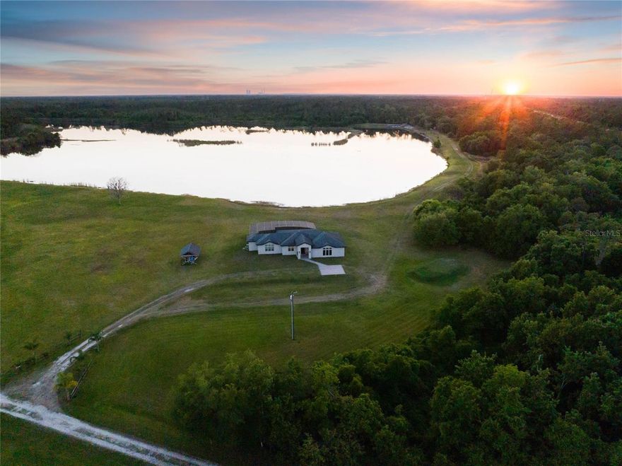 One or more photo(s) has been virtually staged. MUST SEE TOUR LINK! Encompassing 227+/- acres across three parcels, this exceptional property offers a rare chance to indulge in unparalleled seclusion and natural beauty.Lake Ronix, dubbed by industry innovators, is renowned as a private watersports compound, offering unparalleled exclusivity for wakeboarding, wake surfing, and cable riding.With no other boats to compete with,it stands as a haven for water sports enthusiasts seeking privacy and premium facilities. Lake Ronix is known for hosting world-class riders and fostering innovation in the industry, making it a true private paradise for watersports.At the heart of this unique property are two private recreational lakes with the front lake spanning an impressive 80 +/- acres and the back lake spanning 20+/- acres respectively.Whether you're casting a line for bass and crappie, enjoying leisurely boat rides,or thrilling water sports like wakeboarding,these private lakes ensure that every day is filled with adventure and relaxation.Surrounded by lush Florida foliage, this property serves as a haven for Florida wildlife;from deer and turkeys to bobcats, bears, quail, and even otters, the land teems with native species, providing nature enthusiasts with abundant opportunities to observe and cherish the diverse biodiversity of the area. There are also two residences, each on a separate parcel. Situated on the 9 acre parcel is a a fully custom-built ranch-style home constructed in 2016. The open concept split floor plan boasts 2,650 +/- sq/ft, three bedrooms and three full baths, along with a spacious game/media room. The chef's kitchen, complete with an oversized island and seating, serves as the heart of the home, inviting gatherings and culinary creations. The well-conceived floor plan incorporates expansive all-glass sliding doors, providing unmatched views from every angle and seamlessly integrating the home with its natural surroundings.The outdoor living space boasts a screened extended lanai, complete with a heated pool and spa, offering the perfect space for relaxation and enjoyment year-round. Situated on the 7 acre parcel, the 2nd home is a quaint farmhouse dating back to the 1950s adding a touch of nostalgia to the property.This farmhouse holds the potential for renovation or rebuilding, presenting numerous possibilities for modification and transformation.The property also features a spacious 30x40 metal building providing ample storage for boats, recreational vehicles, and/or farm equipment. No deed restrictions or HOA!The property invites exploration and customization, whether as a private watersports compound, family estate, ranch, equestrian center or hunting lodge, this unique Florida paradise offers endless possibilities. The location offers the best of both worlds with a rural living lifestyle yet within a convenient 30-minute drive to the pristine beaches,Cape Canaveral, and approximately 25 miles to Orlando International Airport. Additionally, outdoor enthusiasts will appreciate the nearby opportunities for soccer training facilities, hiking, fishing, and equestrian trails at nearby parks such as East Orange District Park, The Halscott Reserve and Orlando Wetlands Park. With direct road frontage to State Road 50, enjoy seamless connectivity to major thoroughfares, including the State Road 520, the 408 East-West Expressway. Additional parcels included in list price PID 32-22-33-0000-00-002= 210.43 acres and PID 32-22-33-0000-00-005= 7 acres.