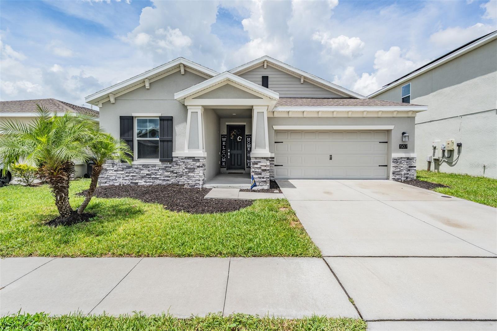 Welcome to 507 Patton Loop, where charm meets smart living in the heart of Liberty Ridge. This Lennar NEXTGEN home offers an attached in-law suite with its own laundry, kitchenette, and garage access! Perfect for accommodating family, guests, or passive rental income. Built in 2021, this thoughtfully designed 3-bedroom, 3-bath home isn’t just move-in ready—it’s live-in-and-love-it ready! Pull into the driveway, admire the tastefully manicured landscaping, and you’ll instantly feel the pride of ownership. The covered front porch invites you to slow down and stay awhile. Inside, the open layout is filled with natural light and high ceilings. The kitchen shines with stone countertops, stainless steel appliances, and plenty of space to gather. The luxurious primary suite offers privacy and comfort with a spacious bathroom and ample storage. Modern living is made easy with smart home features, double-pane windows, and solar panels that keep energy bills in check! The fenced backyard features a screened in and covered patio, making the space ready for pets, play, or your personal touch. Additionally, the home is conveniently located just minutes from the new Polk Parkway extension which will allow for an easy commute to Tampa or Olando. This community offers a low HOA and NO CDD, giving you the community feel at an affordable price. If you’re looking for something that just feels right—stylish, practical, and welcoming—you’ll want to see this one in person! Ask about the low assumable VA rate and schedule your showing today!