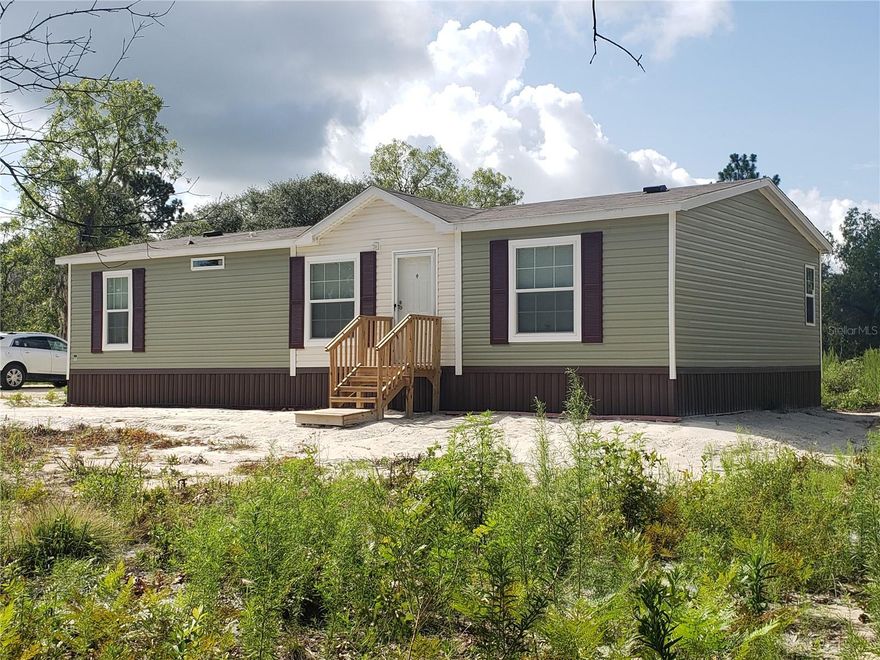 PRICE IMPROVEMENT!!! This brand-new move-in ready mobile home is located in quiet Williston Highlands development. Light and bright. The floors are vinyl throughout the house. No carper. Split plan provides privacy and comfort for you and your guests. Ceiling fans are in every room. Every bedroom is big enough to accommodate a king-size bed, side tables and a dresser. Walk-in closet and in-suite bathroom are in the master bedroom. Double sink, bathtub and a walk-in shower are in master bathroom. All windows have blinds and curtains. Sliding door leads to the spacious back yard. Bring all your toys: boat, RV, 4weel, playground. There is enough space for everything on 1 acre lot. No HOA, CDD or any deed restrictions. Close to Bronson, Williston, Ocala and Gainsville. Just minutes from schools, restaurants and shopping! Come, see and fall in love with this house and call it your home! This house is waiting for you! It will not last long on the market.