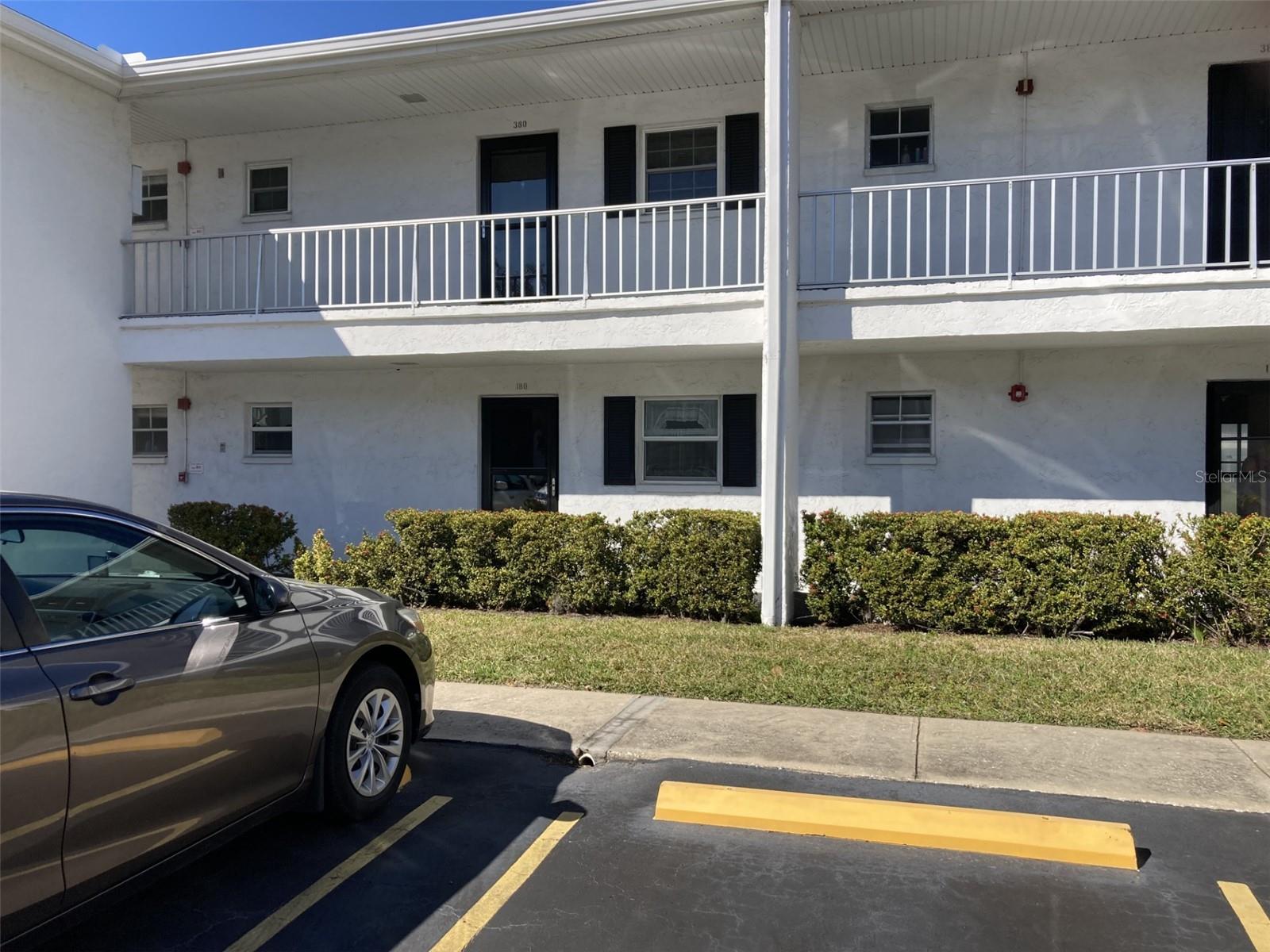 Exceptionally nice first floor turnkey furnished condo overlooking a spacious greenbelt area with mature landscaping. The kitchen has light wood cabinets plus newer appliances including built-in microwave and tile floors. There is a walk-in shower in the bathroom and newer vanity. Lanai is glass enclosed with tile floors and storage closet - perfect place for your computer desk and hide-a-bed for company. Ceiling fans in kitchen, dining room, bedroom, bath and porch. A/C system new 1/25/24 with 5 year warranty on parts, newer electric panel and windows in kitchen and bath have been replaced. Outside lanai is a small patio and a short distance to picnic table and grill. Outside electric meter for the building has been replaced. Within the community is a clubhouse, with activities, heated pool laundry facilities and shuffleboard. This is a 55+ community, one small pet allowed. Close to shopping, about ten miles to the beach and 20 minutes to the airport.
