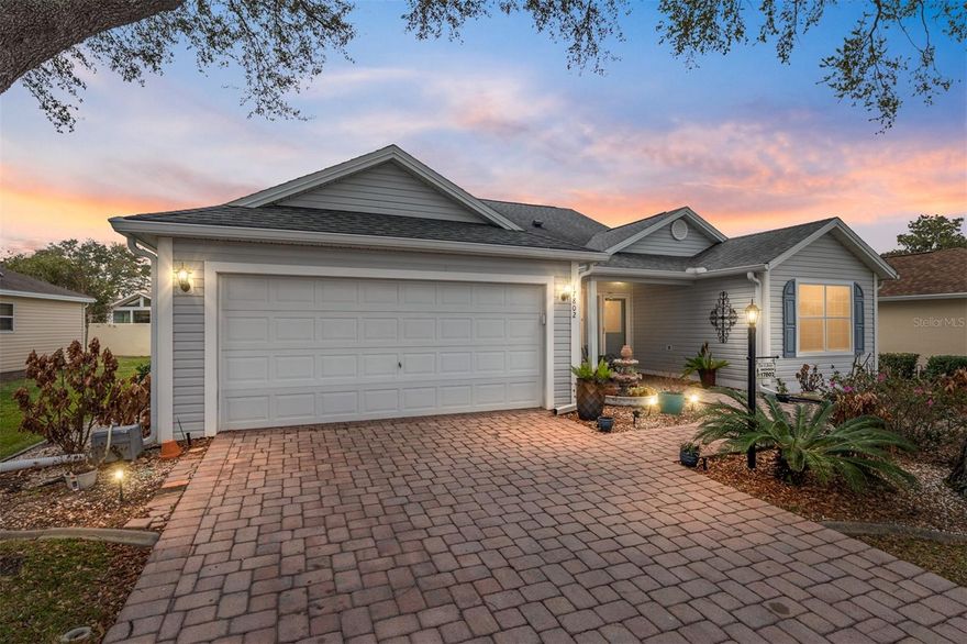 Welcome to this beautifully maintained HIBISCUS DESIGNER MODEL in the sought-after VILLAGE OF PIEDMONT at 17802 SE 85TH ELLERBE AVE, THE VILLAGES, FL—THE BOND IS PAID  and is ideally located near golf, recreation, shopping, and everyday conveniences that define The Villages lifestyle.
Inside, you’ll find TILE FLOORING THROUGHOUT and a comfortable, open layout designed for easy living and entertaining. The kitchen features GAS COOKING, STAINLESS STEEL APPLIANCES, A SOLAR TUBE FOR NATURAL LIGHT, A PANTRY CABINET, and PULL-OUTS.
The spacious primary suite offers HIGH CELINGS, TILE FLOORING, SLIDER ACCESS TO THE LANAI, DUAL CLOSETS, LINEN STORAGE, DUAL SINKS, AND A SEPARATE TILED WALK-IN SHOWER. The GUEST BATH INCLUDES A TILED SHOWER, and the FRONT FLEX ROOM (NO CLOSET) works perfectly as a DEN, OFFICE, OR HOBBY SPACE. Enjoy Florida living year-round in the ENCLOSED LANAI WITH PAVER FLOORING, ACRYLIC WINDOWS, AND A MINI-SPLIT SYSTEM, overlooking a PRIVATE BACKYARD WITH A WALL FOR ADDED PRIVACY. Additional highlights include NEWER WASHER & DRYER, INSIDE LAUNDRY ROOM with CABINETS AND UTILITY SINK, GARAGE CABINETRY, PULL-DOWN ATTIC STAIRS, NOVA WATER FILTRATION SYSTEM, AND UPDATED SPRINKLER SYSTEM WITH BACKFLOW (JAN 2026).
Major updates provide peace of mind: ROOF (2020), GUTTERS (2021), AND UPDATED HVAC 2013, HOT WATER HEATER 2019.
LOCATION & NEARBY AMENITIES: The Village of Piedmont is perfectly positioned close to some of the area’s most popular recreation and golf options. Residents enjoy convenient access to MULBERRY GROVE RECREATION CENTER AND CHATHAM RECREATION CENTER, offering POOLS, FITNESS, PICKLEBALL, TENNIS, AND DAILY ACTIVITIES. Golf enthusiasts will appreciate being near the NANCY LOPEZ LEGACY CHAMPIONSHIP COURSE as well as nearby EXECUTIVE COURSES INCLUDING BRIARWOOD, CHATHAM, AND PIMLICO, providing a variety of play options just minutes away. Shopping, dining, medical, and everyday conveniences are close by at MULBERRY GROVE SHOPPING DISTRICT, and nightly entertainment is easily accessible at the town squares. This well-cared-for HIBISCUS DESIGNER offers COMFORT, UPDATES, AND AN IDEAL LOCATION—an excellent opportunity to enjoy the lifestyle and convenience that make THE VILLAGES one of Florida’s most desirable communities.