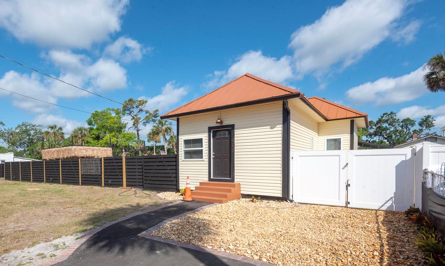 SELLER IS WILLING TO DO OWNER FINANCING WITH 50% DOWN-CONTACT THE LISTING AGENT TODAY FOR MORE DETAILS! RARE OPPORTUNITY IN PORT ORANGE- MUST MAKE AN APPOINTMENT TO VIEW HOME AS ITS BEING ACTIVELY USED AS A AIR BNB! This is your chance to own a truly unique 0.56-acre industrial-zoned property located in the highly desirable Port Orange School District. High and dry during the last hurricane’s , this lot features 150 feet of road frontage along Herbert Street, with a strong daily traffic count of approximately 7,100 vehicles. With NO HOA or deed restrictions and two separate lots—one measuring 0.25 acres & the other 0.31 acres—combined for a generous total of 0.56 acres, offering endless possibilities! A fully renovated 2-bedroom 2-bath home sits on the property, offering 1,016sqft of living space and being sold fully furnished . Renovated in 2023-2024, updates include a brand-new roof, HVAC, plumbing, electrical, windows, doors, flooring, cabinetry, fresh paint inside and out & so much more. Whether you’re looking to make it your personal home, a rental property or use it as an office space, it’s ready to go. Along with its impeccable interior, enjoy your own private oasis in the back with a paver-maxed out patio that provides a secluded backyard retreat complete with a portable hot tub—perfect for relaxation or entertaining. An oversized 10x40 storage shed offers an additional 400 sqft of workshop, office or storage space. The location is incredibly convenient – tucked away just off Ridgewood Ave (US-1), with quick access to the Halifax River, Daytona Beach, the airport, and major highways leading to Jacksonville, St. Augustine, Tampa, and Orlando. Permitted uses for this industrial-zoned lot include mini-warehouses, vehicle/boat storage and repair, commercial or industrial services, construction contractor yards, business services, taxidermy, transportation services, and more. Whether you’re looking to build, expand, or live where you work, this property offers the flexibility and location to make your vision a reality.