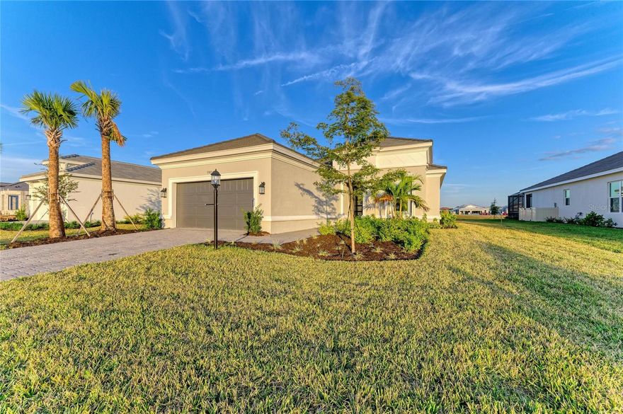Move-in ready and available for immediate closing, never lived-in, this beautifully upgraded MODEL HOME offers the rare opportunity to enjoy resort-style living in the premier golf community of Esplanade at Azario in Lakewood Ranch. Perfectly positioned on a waterfront homesite, this residence blends refined design, modern comfort, and effortless indoor-outdoor living.

Featuring 3 spacious bedrooms, 3.5 luxurious bathrooms, and a private flex/study room with double doors, the home’s thoughtfully designed 2,100+ square-foot interior feels both open and intimate, offering ideal spaces for entertaining, working, or relaxing. Elegant finishes are showcased throughout, including tray ceilings, upgraded floor tile, crown molding, quartz countertops, and upgraded lighting and under-cabinet illumination that add warmth and sophistication to every room.

Designed for cooking and gathering, the gourmet kitchen boasts upgraded cabinetry, quartz counters, stainless-steel premium appliances, a motion-sense faucet, and a large island perfect for casual dining or hosting. Just off the kitchen, the light-filled great room flows seamlessly onto the extended covered lanai, already equipped with a summer-kitchen rough-in, making it effortless to enjoy year-round outdoor living with serene water views.

Each bedroom enjoys its own beautifully appointed bathroom featuring upgraded faucets, quartz counters, frameless shower enclosures, and modern finishes that enhance the home’s luxury feel. Window treatments throughout add convenience and style, while impact-resistant windows offer peace of mind.

Car enthusiasts, hobbyists, or those needing additional workspace will appreciate the tandem 3-car garage, complete with keyless entry, upgraded acrylic floor coating, and flexible space for storage, fitness, golf gear, or workshop setup. An upgraded front entry door and coded lock further elevate the home’s modern functionality.

Beyond the home itself, Azario Esplanade delivers an unmatched resort lifestyle. Residents enjoy access to an 18-hole championship golf course stretching over 7,000 yards, a state-of-the-art fitness center, movement studios, and a spectacular resort-style pool. The community offers multiple dining experiences including the popular Bahama Bar, Toasted Café, and the highly anticipated Culinary Center. Additional amenities include a world-class spa and wellness center, tennis and pickleball courts, bocce ball, pet programs, and a full calendar of social and recreational activities designed for all interests.

Set within the heart of **Lakewood Ranch—consistently ranked one of the top-selling master-planned communities in the country—**this model home is just minutes from exceptional shopping, a wide variety of dining options, vibrant entertainment venues, top medical facilities, and some of the world’s most celebrated Gulf Coast beaches.

Offering a rare combination of a move-in ready model, premium waterfront location, extensive upgrades, and access to unmatched amenities, this home delivers the ultimate luxury lifestyle in one of Florida’s most sought-after communities.