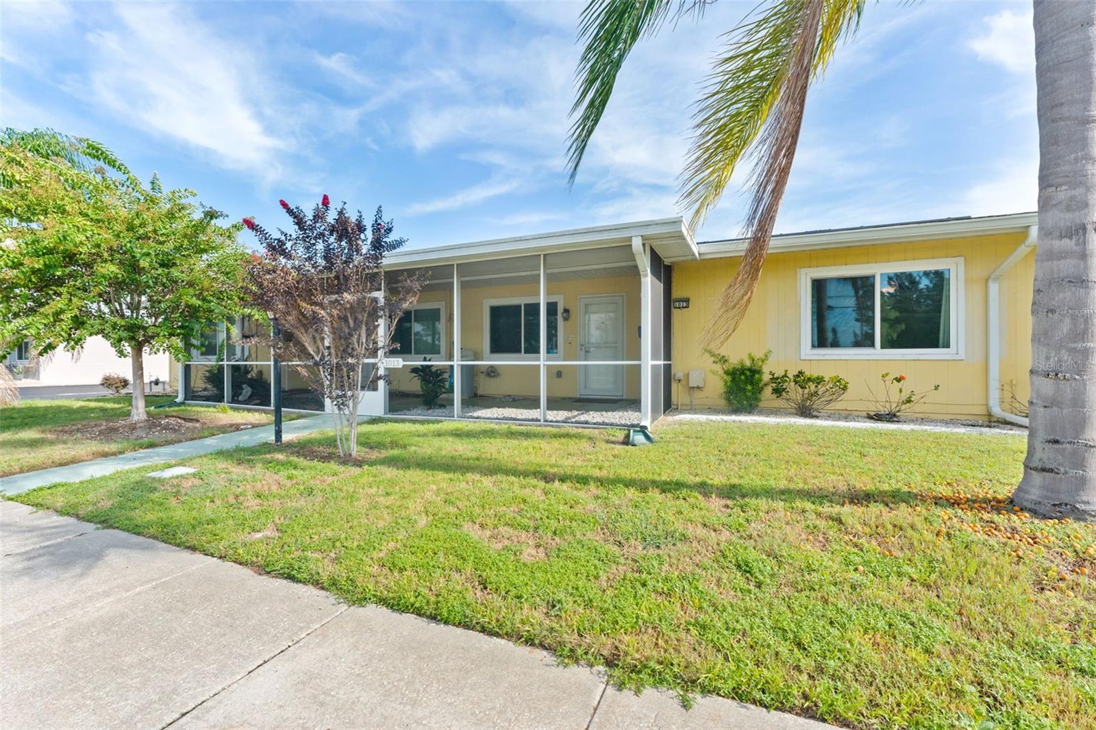 Welcome to 1013 Rickenbacker Dr, where low-maintenance living meets plenty of room to spread out. This spacious 2-bedroom, 2-bath villa is tucked in the heart of Sun City Center, giving you easy access to shopping, dining, golf, and the endless list of community amenities.
Out front, you’ll find a screened-in porch perfect for sipping your morning coffee and waving to neighbors. Step inside to a bright, open layout with neutral tile and terrazzo floors—no carpet here, just easy-to-clean surfaces. The kitchen has stainless steel appliances, plenty of counter space, and a peek into the dining and living areas so you can still be part of the conversation while you cook.
The Florida room, splashed with bold blue accent walls, is a sunny bonus space for hobbies, an office, or just relaxing with a good book. Both bedrooms are generously sized, and the primary has an ensuite bathroom.
Out back, enjoy your own private courtyard—fenced and partially covered—ideal for grilling, container gardening, or simply soaking in the Florida weather. A roomy one-car garage and additional parking in the rear make life even more convenient.
If you’re ready for a home that’s comfortable, practical, and move-in ready, this is the one to see.