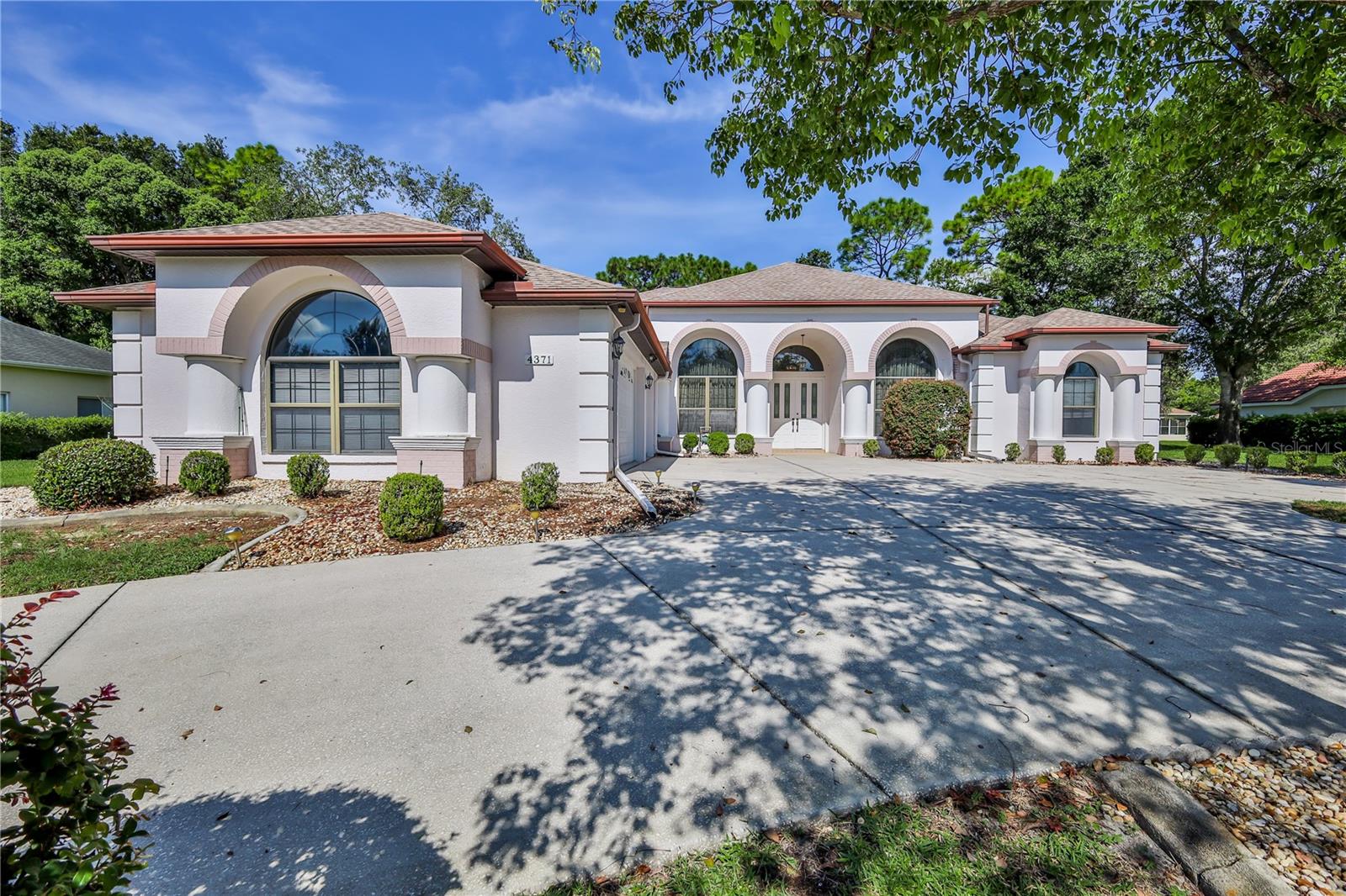 Welcome to 4371 Hunters Pass in the sought-after gated golf community of Silverthorn in Spring Hill! This impressive 4-bedroom + office, 3-bathroom pool home with oversized 3 car Garage offers a perfect blend of elegance, comfort, and functionality - ideal for families or anyone who loves to entertain. Great curb appeal with a circular drive and additional parking. Step inside the double door entry into a large foyer looking straight out to the pool! You'll find formal living and dining rooms, along with a chef's dream kitchen featuring endless wood cabinetry, Corian countertops, a huge walk-in pantry, breakfast bar, and large eat-in area. The kitchen opens to a spacious family room, both of which overlook your private screened-in pool and lanai - perfect for weekend gatherings or relaxing evenings. The primary suite is a true retreat, with a French door to the lanai, oversized walk-in closet, additional closet space, and a luxurious en-suite bath featuring dual sinks, Jacuzzi tub, step-in shower, and private water closet. This thoughtfully designed split floor plan places three additional bedrooms and a full bath on the opposite side of the home - ideal for privacy. Need extra space? The dedicated office is perfect for remote work or could easily convert to a 5th bedroom. Theres also a dedicated pool bathroom and a large laundry room with built-in storage, folding counter, and utility sink for added convenience. Some additional features are BRAND NEW ROOF, new HWH, lanai screens, well pump and irrigation heads. Other features are dual air conditioners, storm shutters, new toilets, lanai is rescreened. Upscale features are in wall oven and microwave, double crown molding and medallions over chandeliers in dining room and foyer. Soaring, arched windows in the dining and office really show off the 12 ft ceilings. This is a diamond waiting for you to make it shine! Why wait to build your dream home, when you can make this bargain yours! Located in a guard-gated, amenity-rich community, enjoy access to a Jr. Olympic-size pool, state-of-the-art fitness center, tennis & pickleball courts, basketball court, playground, community center with classes and events, on-site restaurant, and of course, the beautiful championship golf course. If you're looking for space, style, and a community that has it all - 4371 Hunters Pass is the one!