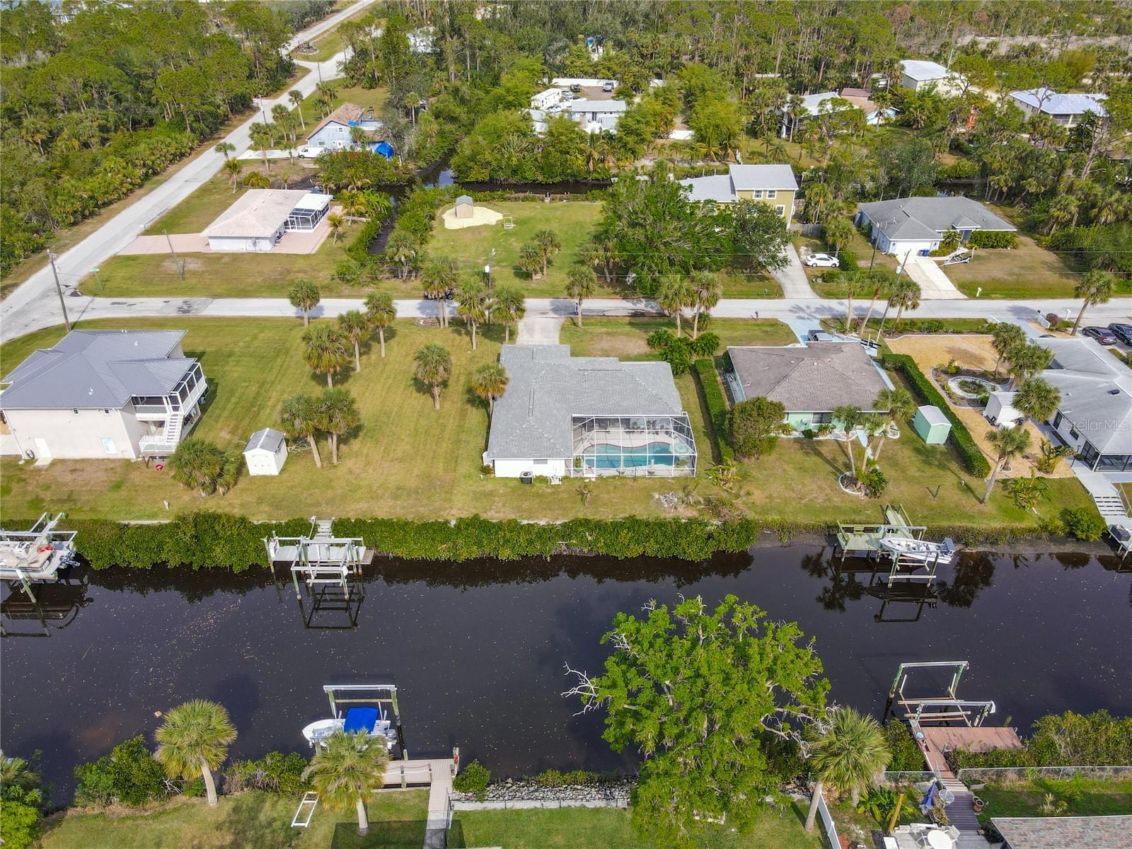THIS qualifies for USDA 100% financing as well! Fish from your backyard with this Myakka River canal front beauty! **1% discount off loan amount with our preferred lender! ** Experience the perfect blend of waterfront living and convenience in this stunning Tarpon Point pool home, just minutes from US 41 and River Road in Venice. Offering quick access to the Myakka River, this property boasts a NEW ROOF (2023) and NEW ELECTRICAL PANEL, along with a range of recent upgrades including an HVAC system (2021). The heated pool was resurfaced in 2021, while the kitchen shines with granite countertops. The interior has been freshly painted, and the split floor plan ensures privacy for all who enjoy their own space. Each of the three spacious bedrooms includes large walk-in closets, and the primary suite opens directly to the pool area for a perfect retreat. The property is fully equipped with a seawall along the canal, offering peace of mind for waterfront enthusiasts. With no deed restrictions, there's ample space for RV or boat storage. Enjoy numerous nearby golf courses, and only a short 12-mile drive to the area's best beaches. This home offers all the best of the Florida lifestyle – pool, waterfront living, and a prime location! Quote for 10LB boat lift and dock installation is $45K. Seller can offer partial financing.