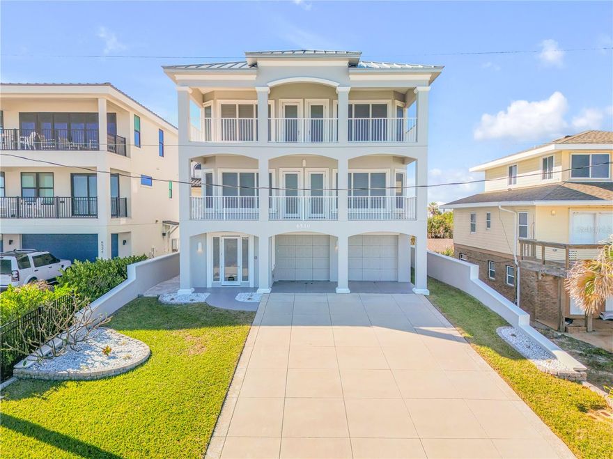 Situated directly on the oceanfront, this 3-story residence boasts an elevator and offers 4 bedrooms (convertible to 5 bedrooms) and 3.5 baths. Encompassing the desirable "no drive" area of New Smyrna Beach, this exquisite home has recently received a new roof in October 2021 and three new HVAC systems in May 2020. Meticulously crafted, the property has been thoughtfully designed to maintain its good-as-new appearance.

The ground level features a private beach walkover with benches for optimal viewing. Right inside the entrance on the ground level, you'll find a spacious foyer hall and a curved staircase leading up the south side. Adjacent to the staircase is a generously sized two-car garage. Additionally, the first floor offers a storage closet, two bedrooms, a bathroom, elevator access, and a west-facing outdoor patio.

Moving up to the second floor, you'll be welcomed by an open and airy layout. With its coffered ceilings, wood flooring, granite countertops, "Jack Busby" cherry cabinets, two double ovens, microwave oven and built-ins, this space exudes elegance. The second floor also features a separate dining area and a breakfast nook situated next to the island, complete with bar-height chairs. All of these spaces effortlessly flow together and provide breathtaking ocean views. A 30x10 covered porch extends the living area, further enhancing the coastal experience. Other amenities on this floor include an 8x6 laundry room with a sink, a half bath, and elevator access.

Ascending to the master floor on the third level, you'll reach the foyer area, which grants access to the private master suite through double doors offering stunning oceanfront vistas. The master suite itself has an attached oceanfront office or optimal fifth bedroom, and encompasses a lavishly appointed bathroom, featuring a soaking tub, walk-in shower, dual vanities, and an enclosed water closet. The suite is complemented by ample closet space with built-ins. Furthermore, the third floor accommodates an extra bedroom, another bathroom, and a sitting area or library that opens onto a west-facing balcony with views of sunsets and the Intracoastal Waterway.

This oceanfront residence showcases balconies and patios on both the east and west sides, allowing for optimum enjoyment of sunrise, rocket launches, beach activities, and sunset views complemented by refreshing evening breezes. An easy 2.5 block walk to the famous JB's fish camp. The home offers an array of special features, including 8' raised panel 1-3/4" thick solid doors, chair rails, double crown molding, stairstep scroll embellishments, two hot water heaters, one A/C unit per floor (three in total), sturdy plantation shutters, elegant wrought-iron spindles, and more. Do not miss out on the opportunity to view this well-maintained home, as it is truly a must-see.