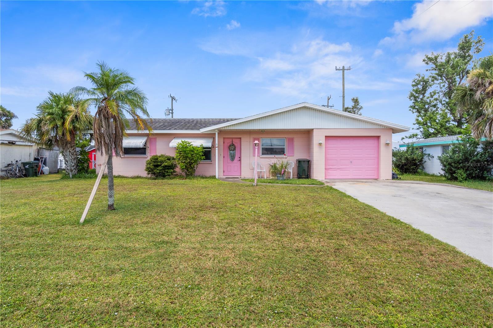 Welcome to 273 Venice East Boulevard — a cheerful and lovingly maintained 3-bedroom, 2-bathroom home nestled in the desirable, non-deed-restricted community of Venice East. From the moment you arrive, you’ll be drawn to its unique curb appeal — a pastel pink exterior with matching accents, tropical palm trees, and a welcoming covered front porch perfect for morning coffee or evening relaxation.
Step inside to a bright, inviting interior filled with natural light and a warm, coastal vibe. The open living and dining area features a charming color palette, polished terrazzo floors, and plenty of space for gatherings. Just beyond, a cozy sunroom offers additional living space to unwind, entertain, or enjoy the Florida sunshine year-round.
The kitchen boasts ample cabinet storage, generous counter space, and a convenient breakfast bar that connects seamlessly to the dining area — making meal prep and entertaining effortless. All three bedrooms are comfortably sized, and the primary suite includes its own private bath for added convenience.
One of the home’s highlights is the spacious Florida room, perfect for enjoying the sunshine year-round. Whether you envision it as a reading nook, hobby space, or an additional lounge for entertaining, this versatile area brings the outdoors in and adds to the home’s comfortable, breezy atmosphere. Out back, the yard offers endless possibilities from creating a lush tropical garden to adding a patio for outdoor dining. With no HOA restrictions, you’ll have the freedom to store a boat, RV, or personalize the property to suit your lifestyle.
The location is unbeatable, just minutes from Venice Beach, historic downtown Venice, golf courses, shopping, dining, and beautiful parks. Whether you’re searching for a full-time residence, a seasonal retreat, or a smart investment property, this home delivers the perfect blend of charm, comfort, and location.
Don’t miss your chance to own a piece of Florida paradise, schedule your private tour today!