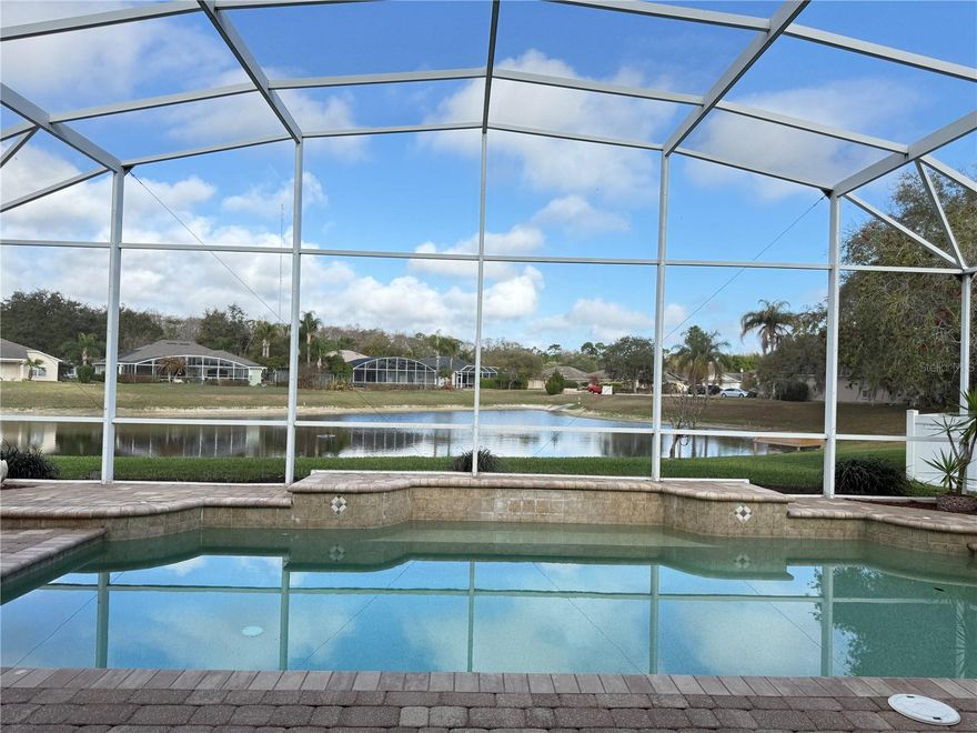 This beautifully maintained 3Bd, 2Ba, 2 Car Garage, screened-in pool home offers an open floor plan living. There are lakeviews from most rooms, a wood burning fireplace, a spacious primary suite and relaxing backyard.  Freshly painted and new carpeting through the bedrooms. The kitchen has GE appliances, convection microwave, a Samsung side-by-side refrigerator/freezer and marble tile backsplash. The inside laundry room is enhanced with a separate deep sink.  Remote control sunshades/hurricane screens across the back lanai. Additional storage accessed by pull-down stairs in the garage.  The exterior of the home has mature landscaping and includes an outdoor shower, screened-in back patio and saltwater pool.  This property is not in a flood zone.  Minutes to the beach, Historic Flagler Ave and Canal St shopping dining and entertainment.