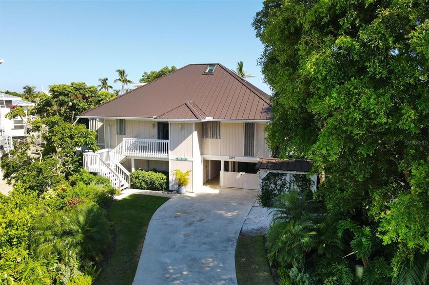 This wonderful property boasts 126 feet of pristine waterfront dockage,(6000 lb lift) providing you with unparalleled direct access to the area's finest fishing and boating experiences. Much of the interior, of this 4 bedroom, 3 1/2 bath home, has been thoughtfully upgraded to offer a comfortable and casual living experience.  The spacious waterfront main bedroom is a serene retreat, allowing you to wake up to breathtaking views of the water every morning. The second level bedrooms enjoy a shared, updated full bath and private deck. Private guest accommodations are ground level and open to the lovely backyard and waterfront. The heart of this home extends to the outdoors, where an oversized porch, featuring mahogany ceiling details, beckons you to relax and unwind. Step outside to discover your private oasis—a sparkling pool that invites you to take a refreshing dip or simply lounge by the water's edge. All within a short distance to the historic Boca Grande village. The metal roof is new in 2023, drywall estimate available.