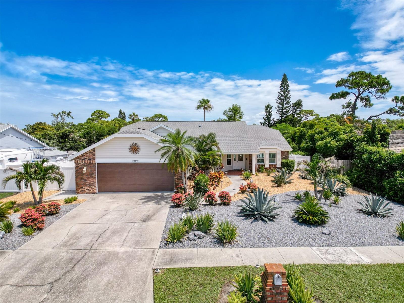 Just steps from the white sands of Sunset Beach, this stunning 4-bedroom, 3-bath, salt-water POOL HOME offers the best of Florida living in a peaceful, walkable, UPSCALE Tarpon Springs neighborhood. Situated on a spacious lot just under a quarter acre, this superbly maintained home is full of upgrades, natural light, and coastal charm. The layout features vaulted ceilings, a large living room with fireplace, formal dining space, breakfast room, and a separate family room with another fireplace ideal for entertaining. The generously sized kitchen has been updated with classic wood cabinetry, stainless steel appliances, and ample counter space for meal prep or gathering with guests. The split-bedroom layout provides privacy for the large master bedroom suite, which includes a slider to the pool, TWO walk-in closets with thoughtfully planned wood shelves, and en-suite bath with double sinks and water closet with walk-in shower. A separate room within the master bedroom is perfect for a home office, reading room, nursery, storage -- you decide!
Three additional bedrooms are located on the opposite side of the home with TWO full baths nearby. One bedroom features an EN-SUITE FULL BATH, making it ideal for guests or multigenerational living. The home features durable flooring throughout -- no carpet! Two sliders lead out to a screened-in lanai with a heated, self-cleaning pool and spillover spa, surrounded by easy-care landscaping and FULLY FENCED for pets, people, and privacy. Enjoy year-round outdoor living with plenty of space for lounging, grilling, or entertaining.
The oversized 2-car garage offers plenty of storage and space for working. Located in a golf cart-friendly community with no HOA or CDD, this home is a short walk to Sunset Beach and just minutes from Fred Howard Park, the famous Sponge Docks, marinas, restaurants, and shopping. Zoned for top-rated schools and surrounded by natural beauty, this property is ideal as a full-time residence, vacation home, or investment opportunity. Don’t miss your chance to live the Florida beach lifestyle without sacrificing space, comfort, or convenience.
Ask about the over $200,000 worth of upgrades made to this home, including water softener, spa heater which can heat the pool, healthy salt water pool system, new septic, HVAC purifier, and so much more.