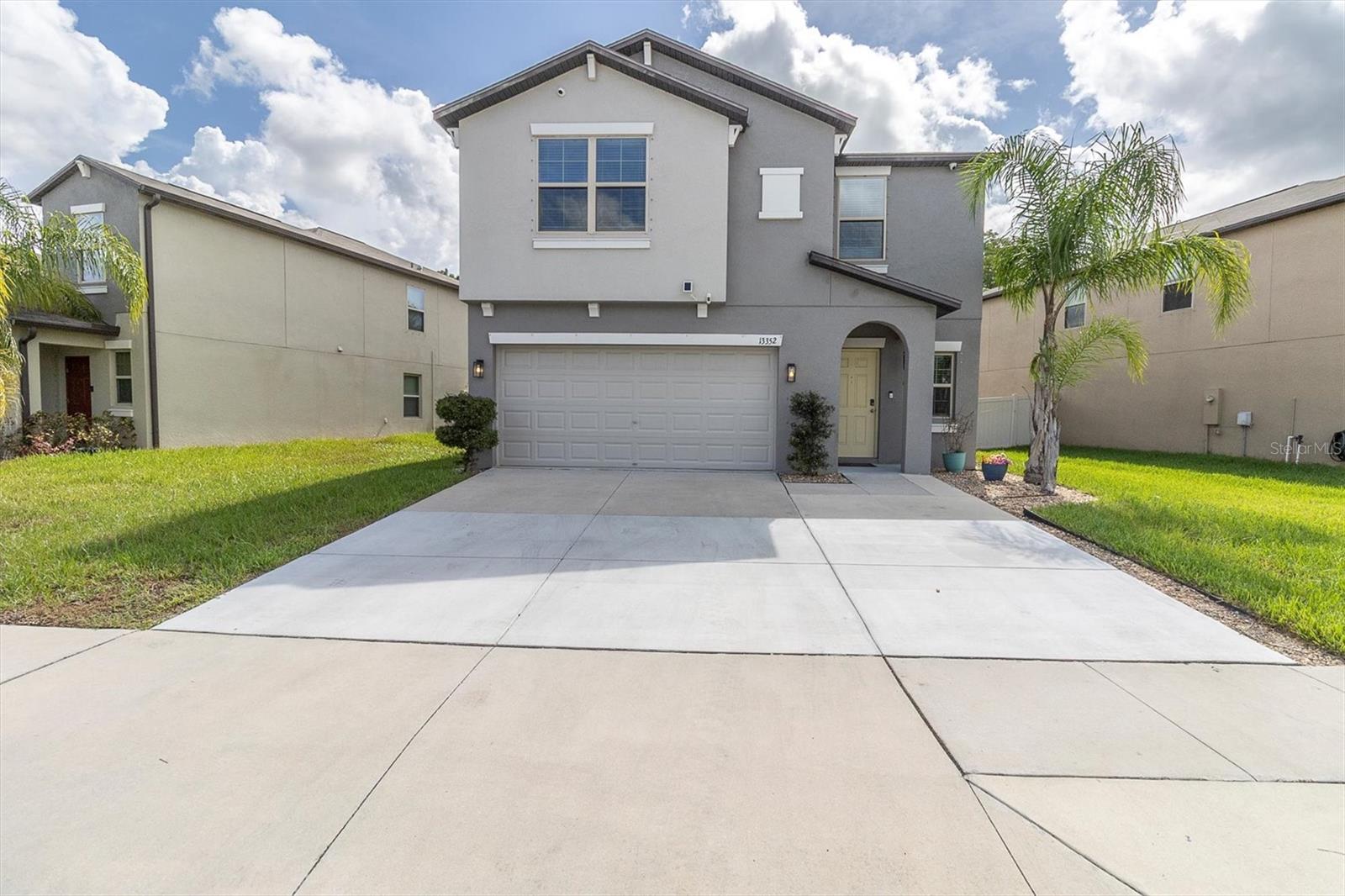 Stop scrolling — this is the one! Welcome Home! where space, style, and Florida sunshine come together in perfect harmony. Tucked inside lakeside , this 5-bedroom, 2.5 -bath beauty is big enough for your whole crew and your in-laws (if you’re feeling generous).Step inside to soaring ceilings, an open floor plan, and natural light pouring in like it pays rent. The kitchen is ready for your inner chef — complete with stainless steel appliances, breakfast bar, and plenty of cabinet space for all your snacks (or Tupperware you swear you’ll organize one day). The primary suite is massive, with double walk-in closets and a bathroom that feels like a mini spa.
Out back? Enjoy your morning coffee or evening glass of wine under the covered patio — bonus: no rear neighbors! Whether you’re hosting the holidays or just binge-watching with your family, this layout delivers. Close to shops, restaurants, golf, beaches, and more. Hudson is booming, and this gem puts you right in the middle of It. Come see why this house is worth the hype!