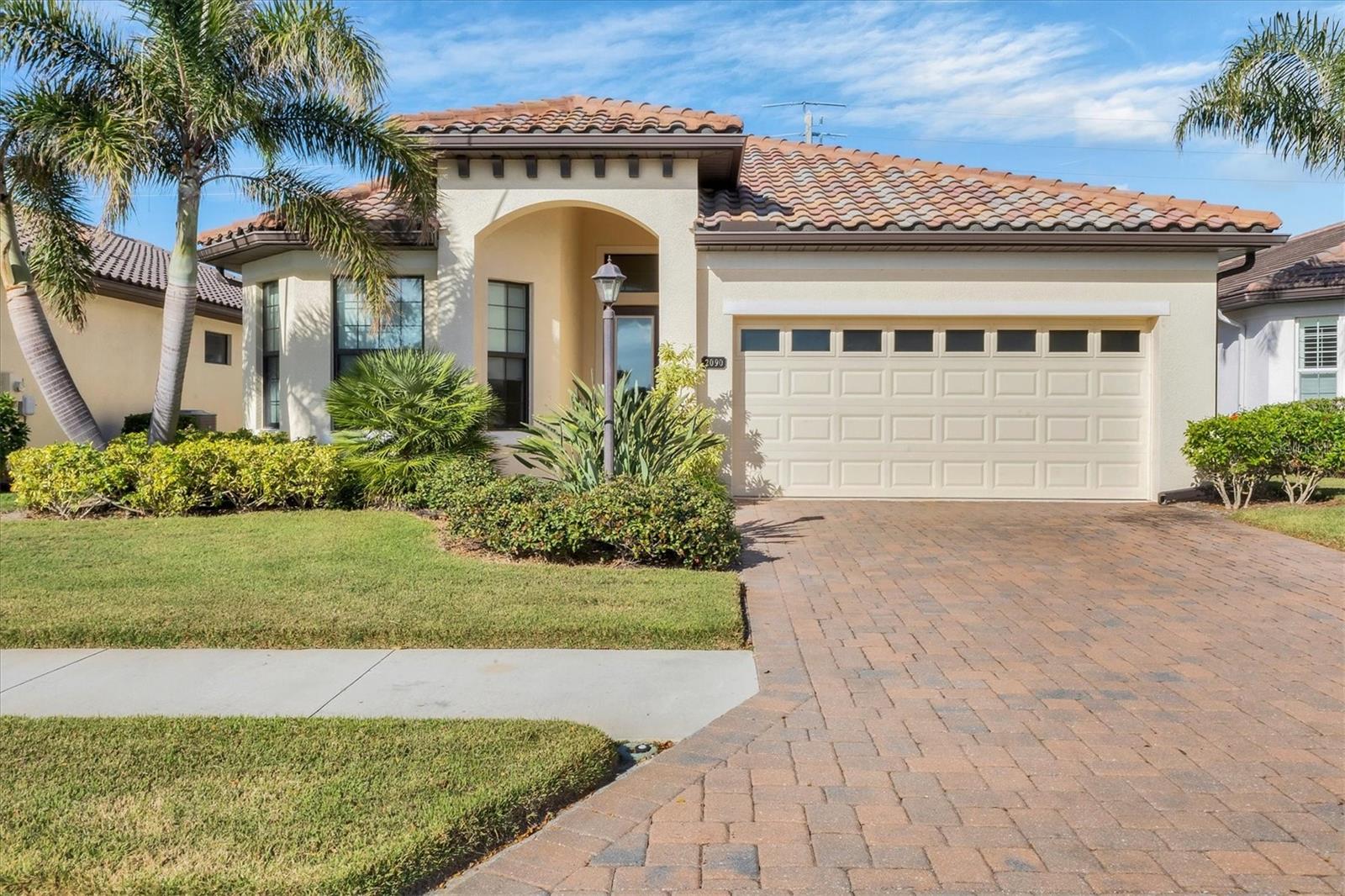 BACK ON THE MARKET AT A REDUCED PRICE...Owner will consider all reasonable offers! This GRAND OAKS home has so much to offer! The appropriately named neighborhood is an intimate enclave of DETACHED MAINTENANCE FREE HOMES so well designed & located. A refined blend of Coastal & Mediterranean architecture with superior craftsmanship & elegant appointments. This former MODEL home is special from the BRICK PAVER drive & walkway, through gorgeous front door, into a flowing floor plan with high end features. Most of the rooms are TILE, 8' doors throughout & volume ceilings with tray ceilings in Great room & Owner's suite. Pocket doors to DEN. GRANITE counters in kitchen & baths, WOOD cabinets in kitchen. Floor plan is perfect for entertaining featuring a gourmet kitchen with breakfast bar, recessed lighting & split bedroom plan offering privacy for all. Large lanai with BRICK PAVERS. Spacious Owner's suite with 2 closets & sumptuous bath! Split vanities & private water closet. Den & 2nd bedrooms are generously sized. IMPACT WINDOWS throughout. Beautifully landscaped. UPDATES: Gutters in 2020, REFRIGERATOR 2020, DISHWASHER 2024, exterior painted 2023. The life-like dog statue in living area is named HAPPY, live 4-legged family members will enjoy living there as well! A GATED & WALLED community offers an active & carefree lifestyle to unwind & forge lifelong memories. NO CDD fees! Residents' Club offers RESORT-STYLE pool with SPA, FIRE PIT, & outdoor grill. Expansive community sidewalks for walking, biking, or running. OUTSTANDING LOCATION minutes from historic downtown Venice, Gulf beaches, shopping & dining. Easy access to I-75. A Superior home in a Superior location. See it today!