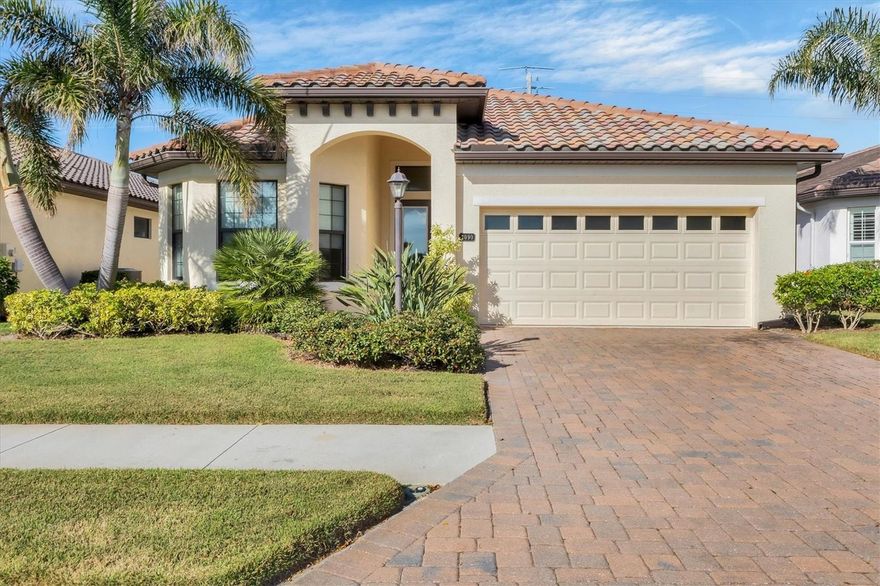 PRICED REDUCED!!! This GRAND OAKS home has so much to offer! The appropriately named neighborhood is an intimate enclave of DETACHED MAINTENANCE FREE HOMES so well designed, well located, with stately oaks throughout. A refined blend of Coastal & Mediterranean architecture with superior craftsmanship & elegant appointments. This former MODEL home is special inside & out. From the BRICK PAVER drive & walkway, through gorgeous front door, into a flowing floor plan with high end features. Most of the rooms are TILE, 8' doors throughout & volume ceilings with tray ceilings in Great room & Owner's suite. Pocket doors to DEN. GRANITE counters in kitchen & baths, WOOD cabinets in kitchen. Floor plan is perfect for entertaining featuring a gourmet kitchen with breakfast bar, recessed lighting & split bedroom plan offering privacy for all. Large lanai with BRICK PAVERS. Spacious Owner's suite with 2 closets & sumptuous bath! Split vanities & private water closet. Den & 2nd bedroom are generously sized. IMPACT WINDOWS throughout which eliminates all outside noise, peaceful & serene inside. Beautifully landscaped. UPDATES: Gutters in 2020, REFRIGERATOR 2020, DISHWASHER 2024, exterior painted 2023. The life-like dog statue in living area is named HAPPY, live 4-legged family members will enjoy living there as well! A GATED & WALLED community offers an active & carefree lifestyle to unwind & forge lifelong memories. NO CDD fees & reasonable HOA fees! Residents' Club offers RESORT-STYLE pool with SPA, FIRE PIT, & outdoor grill. Lovely area to relax, socialize or exercise. Expansive community sidewalks for walking, biking, or running. OUTSTANDING LOCATION minutes from historic downtown Venice, Gulf beaches, shopping & dining. Easy access to I-75. A Superior home in a Superior location. See it today! Owner will consider all reasonable offers!