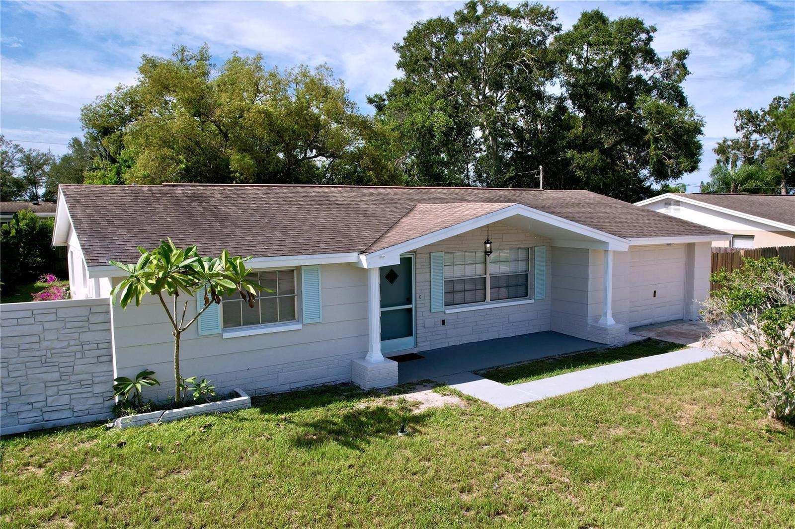 Look at this gorgeous home. It's a renovated, solid block construction, 2 bed 2 bath, 1,175 sq ft house with an oversized 1 car garage and a double car driveway, set in a beautiful neighborhood with walkable sidewalks. There are no HOA, CDD and NOT in flood zone, making this home a very affordable property to upkeep. Conveniently located near grocery and shopping (1.8 miles), easy access to Hwy 19 to get to the beach (6.8 miles to sunset beach) and only 25 miles from Tampa International Airport. Must see in person to appreciate. Includes new paint inside and out, new luxury vinyl floor, new quartz countertop in kitchen and both bathroom, new lower cabinets in kitchen and primary bath, new hardware and much more. Grass in front and back. Huge backyard that's fully fenced in and a covered lanai to enjoy the outdoors. Too much to write, just come and see it! :)