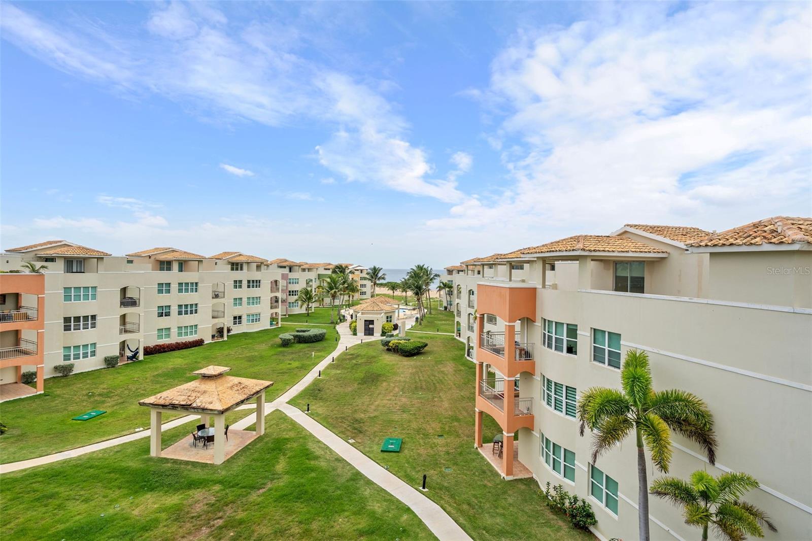 Exquisite Oceanfront Penthouse – Embrace the art of relaxation at this impeccably furnished two story penthouse apartment with a fresh take on modern beach chic.
Conveniently located at Haudimar Beach Apartments in Isabela, a beach front surfers’ paradise. This 2,270 SF turnkey home features 2 spacious bedrooms, convertible to 3 and 3 full bathrooms that amazes with an abundance of natural light in every room. Upon entry, homeowners are welcomed into a cheerful and bright kitchen/dining and living area with a balcony that overlooks the pool area and beach. The ample and renovated kitchen is equipped with stainless steel appliances followed by the laundry room. The primary suite offers a contemporary design with a king size bed, his and hers closets, an ensuite bathroom and majestic views. The second bedroom and bathroom are also located on the first floor. On the second floor you will find the third full bathroom followed by a family room area that is currently being used as a third bedroom. This double height ceiling space has direct access to the penthouse’s principal feature. A sizable rooftop overlooking the beach, excellent for family and friend gatherings. Were unparallel panoramic beach views are awaiting you all day, every day.
Lounge around the pool or settle into a beach chair to soak in the beautiful West side sunsets in this one-of-a-kind community. Short term rentals are allowed making it an ideal investment opportunity. The location gives you easy and convenient access to Jobos Beach, one of the best beaches on the island. The property is a 10-minute drive from the Rafael Hernandez Airport in Aguadilla. Two assigned parking spaces are included with the purchase.