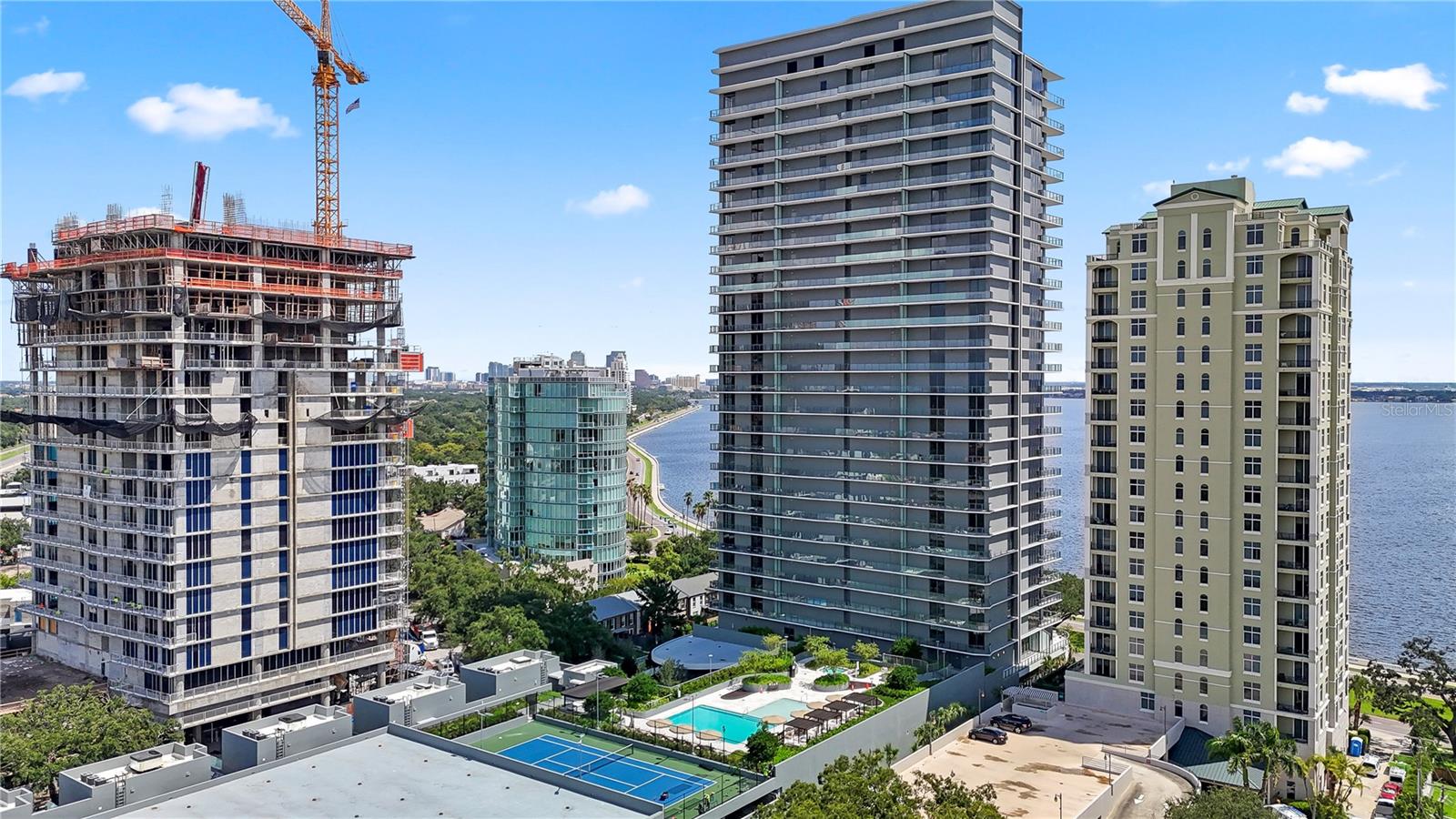 Absolutely stunning Penthouse encompassing 1/2 floor at the luxurious Ritz Carlton Residences with North, East, and Western views offering majestic sunrise, sunset, and city views. Step off the elevator directly into your private home. This home in the sky offers oversized living spaces surrounded by floor to ceiling windows. The large kitchen and dining area overlooks the enormous great room with a wraparound terrace all overlooking the sparkling waters of the bayshore. Also overlooking the bayshore is 1 of the 3 guest suites and the primary bedroom. The owners retreat has over 20ft of floor to ceiling water views, 2 oversized closets and a large and inviting marble tiled bathroom. This unit also features a space for a home gym/den/office with a built-in sauna, 2 more guest suites with a sunset terrace, and a unique living space with a private bath that is perfect for live-in help. In addition to the beautiful private space this residence offers, the building has all the luxury amenities you would expect of a Ritz Carlton including 2 pools, hot tub, grilling area, multiple outdoor common areas, valet parking. a large gym with a group exercise room, complimentary breakfast daily, a board room, kids playroom, golf simulator and a massage room.