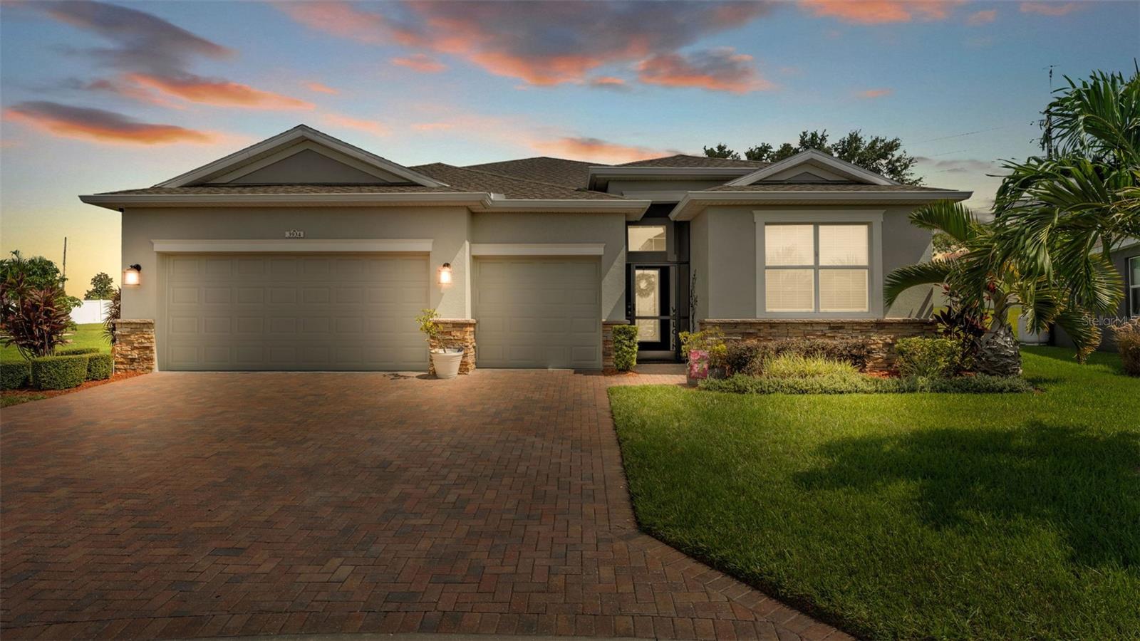 Welcome to 3934 Bedford Avenue, a beautifully maintained 4-bedroom, 3-bathroom home nestled in the sought-after 55+ Traditions at Lake Ruby community in Winter Haven. This move-in ready residence offers a perfect blend of comfort, functionality, and low-maintenance living. Step inside to discover an open-concept layout featuring tile flooring throughout the main living areas, a spacious living room, and a modern kitchen with solid surface countertops, stainless steel appliances, and a breakfast bar. The master suite is a relaxing retreat with a walk-in closet and an en-suite bathroom offering dual sinks and a walk-in shower. Enjoy peaceful mornings or evenings on your massive screened-in lanai with a custom electric fireplace that overlooks lush landscaping and a private backyard setting. Additional highlights include interior laundry, a 3-car garage. Residents of Traditions enjoy resort-style amenities, including a lakeside clubhouse, fitness center, heated pool and spa, tennis and pickleball courts, walking paths, basketball court, sauna, gym, billiards room, craft room, a private boat ramp to Lake Ruby, rentable boat slips, and a full calendar of community activities. Conveniently located near shopping, dining, and medical facilities, golf courses, and LegoLand for the grandchildren, this home offers the best of active adult living in Central Florida. So call today to schedule your private showing before this one slips away!