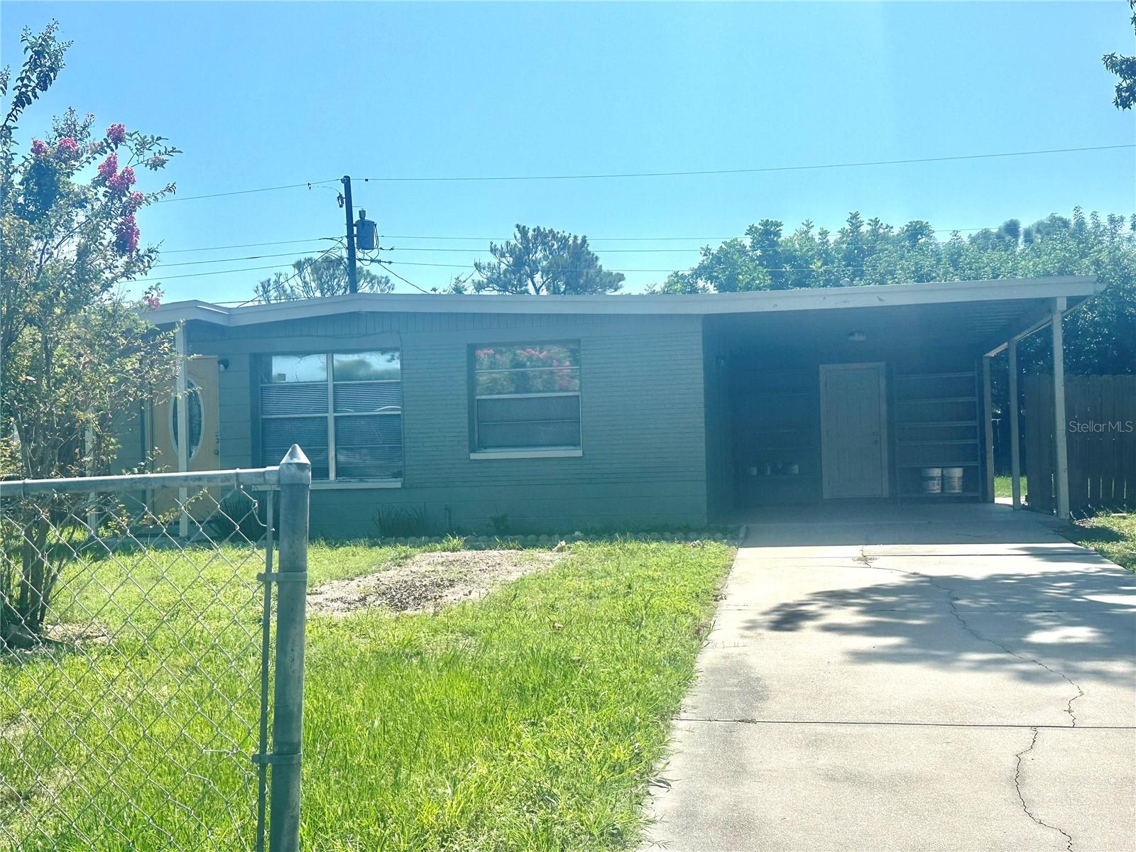 This 840 sq. ft. home offers 3 bedrooms and 1 bathroom, making it an ideal choice for small families, couples, or individuals seeking a practical long-term rental. Inside, you’ll find a bright and spacious living room with plenty of natural light, a functional kitchen with ample cabinet space (microwave not included), and an easy-to-maintain layout designed for everyday living. The large backyard provides a relaxing outdoor space with a charming shell-covered area, perfect for enjoying the Florida weather, entertaining guests, or creating your own garden. A covered carport is included for convenient and protected parking. The home is just minutes from shopping centers, supermarkets, dining options, and local amenities, offering comfort and convenience. Available for a 1-year lease, this property is perfect for those looking for a home with practical features and plenty of outdoor space. Call for a showing