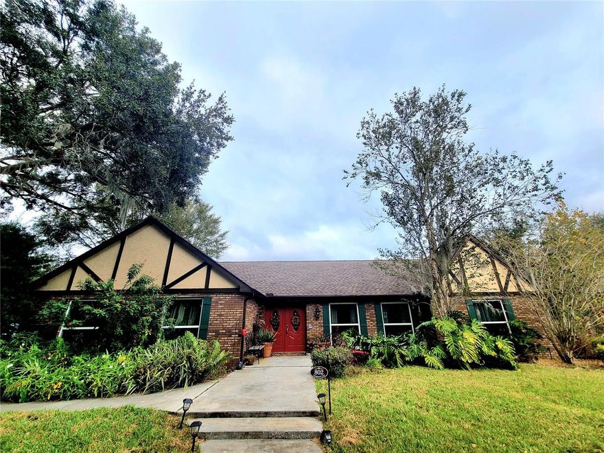 MOTIVATED SELLERS! This simply STUNNING home in the highly desired neighborhood of Indian Hills has FULLY OWNED WHOLE HOME SOLAR the current owners have only paid the meter charge of $22 for the past 3 years! This 4 bed, 3 bath, pool home has DOUBLE MASTER SUITES and features whole home solar, private well with amazing water quality and a septic system that was fully updated 3 years ago keeping your utilities to a minimum. But wait… it get’s better! It has a NEW ROOF and chimney installed in 2023, all new windows in 2020, pool resurfacing and glass tiles in 2019, plus cabinets and granite countertops throughout the home installed in 2018. Are you ready to PUT IN YOUR OFFER? This dream home sits on the VERY BEST CORNER LOT WITH 1 FULL ACRE positioned on an angle to showcase the grand circular drive framing the home plus there is an expansive rear drive way at the side of the home for your boat and RV. Walking up to the double door entry you will find a stone patio directly to the right, perfect for a couple of rocking chairs. Stepping into the home you will be awe struck with the perfectly planned open concept living that is perfect for families and entertaining guests. A kitchen is the heart of the home and this home speaks perfectly to that, anchoring the dining room to the right with floor to ceiling windows that flood the space with natural light and the casual family room with vaulted ceiling, tall stone fireplace, 2 sky lights and the perfect wet bar with wine cork backsplash to the left of the kitchen. The kitchen draws you in with its large granite island with induction cooktop, double confection wall oven with microwave, large sink and cabinets with soft close drawers. Adjacent to the kitchen is a HUGE walk in pantry with tons of storage. The 3 way split bedroom floor plans provides for exceptional privacy, the largest master bedroom features a sliding door with plantation shutters that lead to the screened lanai and HOT TUB, it also boost 2 ample walk in closets, double sink vanity and large walk in shower. Just outside of this master is the home office that could also double as a nursery. The 2 secondary bedrooms are tucked away behind a pocket door, each bedroom is spacious and comfortable with large closets and share a 3 piece bathroom with tub and shower combination. The smaller master bedroom has ample space for an in-law with a nicely appointed bathroom that is also accessible from the bonus room. Speaking of the bonus room WHAT A COOL ENTERTAINING SPACE with a wood ceiling, pass thru from the kitchen, fully surrounded by picture windows to take in the outdoors and sandwiched between the family room and a large screened lanai with a hot tub! As you find your way to your HUGE fully fenced back yard you will discover a secret garden tucked away under the trees, an open air pool with waterfall feature and multicolor underwater lighting all surrounded by pavers, a yard big enough to host family football or soccer games and a SOLAR FIELD! This home with 4 bedroom, 3 bath, 2 HVAC units, hot tub and pool is fully powered by solar, UNBELIEVABLE but true! Since the solar panels are on a ground mount you don’t have to worry about your home insurance complaining about your new roof. What are you waiting for? GET YOUR OFFER IN NOW AND STOP PAYING THAT HIGH ELECTRIC BILL! Most furniture optional to purchase. Home is agent owned who is leaving it all behind to move closer to grandchildren. BRING ALL OFFERS MOTIVATED SELLERS!