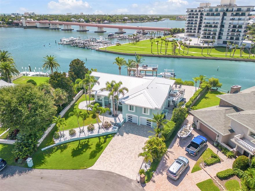 Direct Intracoastal beachside deep water 6Bd, 4 ½ Ba, 2 Car Garage Island home. Exquisitely renovated year 2024. Offered fully furnished. One of the closest homes to the New Smyrna Beach Inlet, this waterfront property allows a quick offshore access without passing under a bridge. One bedroom on the lower level could function as a private in-law suite with its own entrance, full bath and laundry area. All countertops in the home including kitchen, bars, bathrooms and laundry room feature matching quartz. There are wrap around floor to ceiling windows in living room and kitchen and hardwood flooring throughout. The updated chef’s kitchen has two islands, stainless appliances and oversize custom wood cabinets. Custom cabinets are also featured in the laundry room and bedroom closets with 8’ doors throughout the home. The gas fireplace in living room adds to the overall ambiance. High Impact windows, 2 A/C units, no-slip floors in garage are all upgraded extras. Plantation shutters are on all windows. The primary en-suite has a free-standing tub and a huge walk-in shower with two rain shower head and its own laundry room. A circular stairway from the primary suite leads down to a private balcony for relaxing while watching the tranquil waterways. Paver walkways are throughout the property. The pool is equipped with a fountain, lighting features and sun shelf. The custom-built dock includes two boat lifts—a 13,000-lb covered lift and a 16,000-lb lift, both equipped with water and electric. An upper-level entertaining and viewing deck above the boat house has water, electric, furniture, and bar creating the perfect space for hosting many guests for a quiet evening on the water