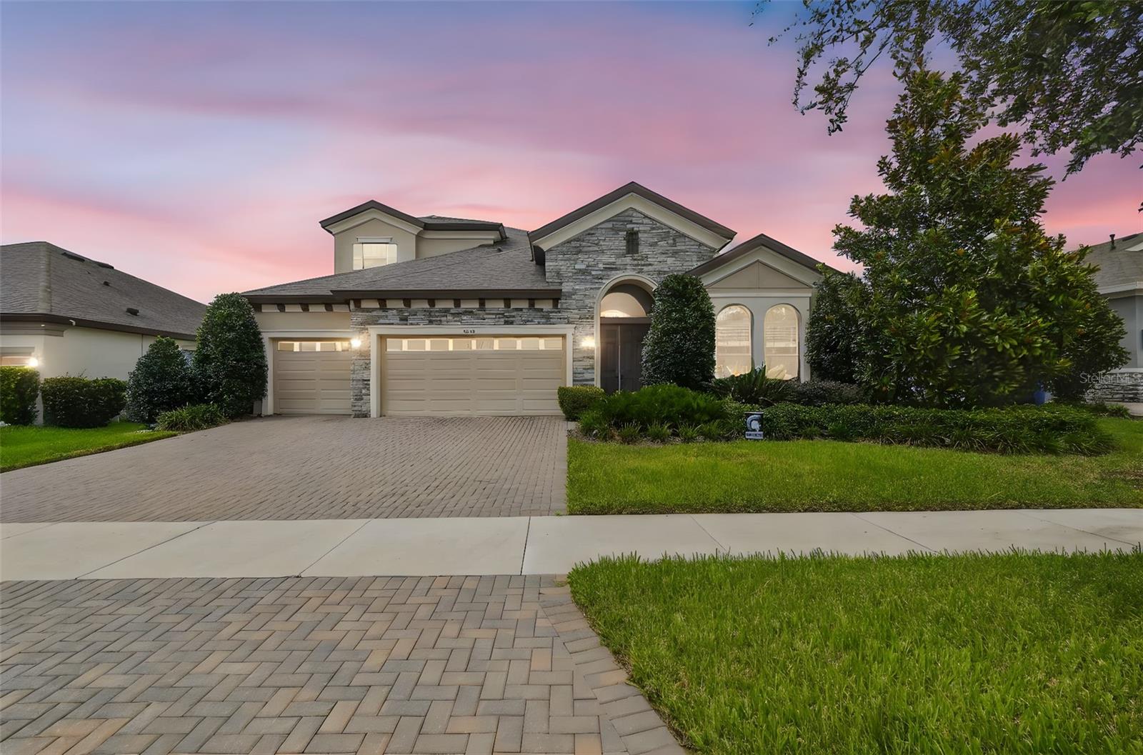 Live the Legacy Ridge lifestyle in this pristine, gated Valrico enclave—complete with manicured grounds and a community dog park. This Biscayne II offers the ideal modern layout: 5 spacious bedrooms and 5 full baths (including a convenient pool bath), with the home’s only upstairs bedroom set privately beside a large bonus room and bath. Soaring 12-ft ceilings crown the expansive great room and gourmet kitchen, where an extended island doubles for prep and casual dining, abundant cabinetry and a walk-in pantry keep counters clutter-free, and a gas range plus oven–microwave combo make cooking a joy. Slide the doors open to your backyard paradise: a beautiful PebbleTec saltwater pool and a wide, screened lanai perfect for relaxing or play. The generous primary suite features two closets and a spa bath with dual sinks, a walk-in shower, soaking tub, and linen storage. Additional highlights include four secondary bedrooms with ample closets, a large laundry room, an oversized 3-car garage, two A/C systems, and an in-wall pest control system—blending comfort, convenience, and low-maintenance living. Recent updates elevate the home even further: whole-home Sherwin Williams Duralast interior paint (2024); Shaw carpet with antimicrobial pad (2023); Culligan whole-house soft-water system (2023); GE Profile dishwasher (2023); dramatic 99" living-room ceiling fan (2023); new bedroom and patio ceiling fans (2024); patio/lanai sealant (2025); and LED can lights with night-light feature (2024). This designer-finished home delivers luxury and livability—schedule your private showing today!