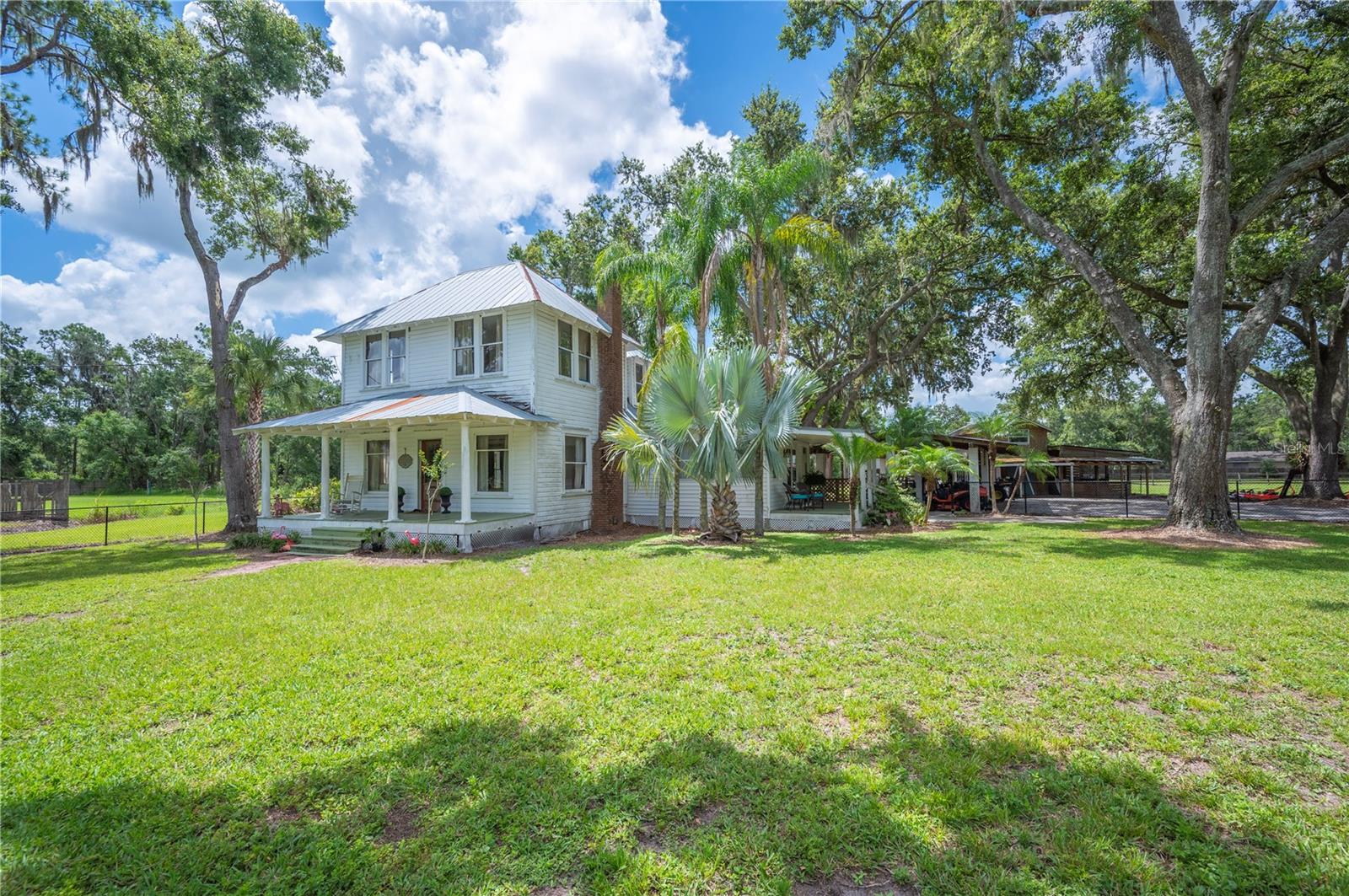 Welcome to your own rural oasis in south Lakeland—where history, charm, and possibility come together on 4.82
picturesque acres. Nestled on a quaint road that ends at a cul-de-sac, this unique property offers a rare chance to create
your dream homestead amongst the beauty of the open space. The centerpiece of the property is a historic 1938
farmhouse with a remarkable story. Originally located at the corner of Lake Hollingsworth Dr and Success Ave, the home
was relocated to its current setting, and the proceeds from its sale helped establish Historic Lakeland, Inc.—the
nonprofit dedicated to preserving the architectural heritage of the city. Today, this 3-bedroom, 1.5-bath charmer is full of
potential, brimming with original details like hardwood floors, crown molding, picture rail trim, and a wood-burning
fireplace that speaks to a bygone era. Outdoors, the property is well-suited for a variety of outdoor activities including
outbuildings that inspire the property's potential. A creek borders the front lot and connects to a serene pond on the
eastern side of the property, offering a peaceful backdrop and a natural water feature. The barn features an apartment
upstairs with plumbing hookups, suitable for a guest suite, office, or creative studio. If you're looking to leave your mark
and restore a piece of Lakeland history while also escaping to a more peaceful pace of life, this property offers the
space, setting, and story to make it truly your own! *** Home being sold as-is, fixer upper, AC upstairs does not work ***
Sale includes both parcels that total 4.82 acres: 23-29-19-000000-022140 AND 23-29-19-000000-022130