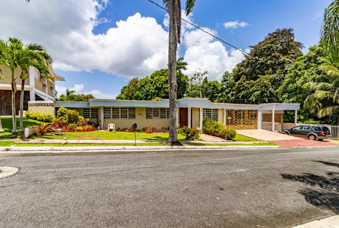 This 2021sq. ft. single-story residence in San Juan, Puerto Rico, offers a harmonious blend of space and functionality. The home offers 3 bedrooms, and an 3.5 bathrooms, ensuring ample space for residents and guests alike. The property's layout includes two distinct living rooms, providing versatile spaces for relaxation and entertainment. The well-designed kitchen features modern appliances, ample counter space, and large windows that flood the area with natural light. A separate dining room offers a dedicated space for formal meals. The home's design emphasizes openness and light, with large windows throughout and sliding glass doors that connect indoor and outdoor spaces. The bedrooms are comfortably sized, with the primary bedroom featuring mirrored closet doors and en-suite facilities. The bathrooms are well-appointed, with modern fixtures and tiled surfaces. The property's multiple living areas and efficient use of space make it ideal for both family living and entertaining guests.