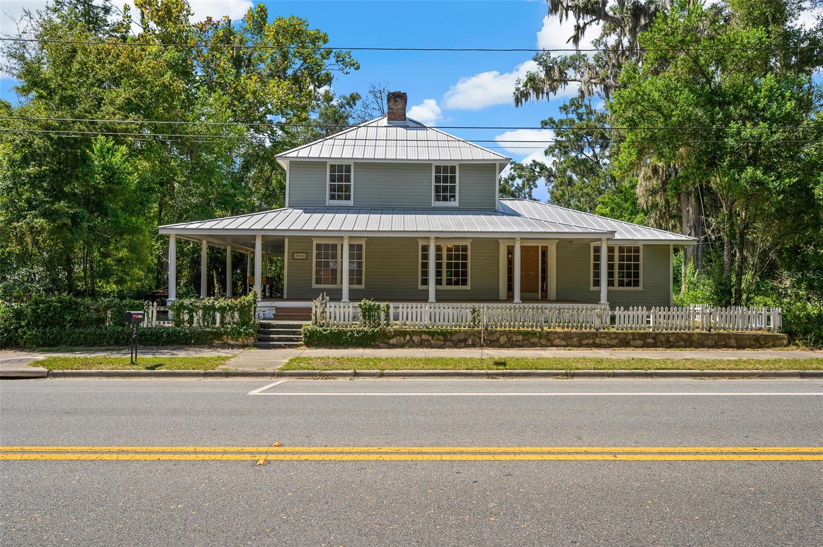 Welcome to a true piece of Historic Florida! Come find a beautifully renovated home where timeless character blends seamlessly with modern comfort.
This spacious residence has been thoughtfully updated with major improvements, including a new commercial-grade metal roof (2019) and dual AC units (2019), updated electrical and plumbing, and stainless steel appliances in a chef-inspired galley kitchen. The kitchen is designed for culinary creativity, offering both style and functionality with a stunning view of the open Florida skies.
Step inside and you’ll find warm hardwood floors, detailed crown molding, and a layout that flows effortlessly. The stunning master bathroom is a true retreat, featuring spa-like finishes that invite you to unwind.
Outside, enjoy a fully fenced yard perfect for pets, gatherings, or simply soaking up the Florida sunshine. Despite its generous size and upgrades, the home maintains a low utility bill thanks to its efficiency.
Best of all, the home is located just 0.4 miles from the charming shops, dining, and historic beauty of downtown High Springs. Property is zoned C2 - mixed use. Currently set up for residential living but can easily be converted for office space or a Bed and Breakfast.