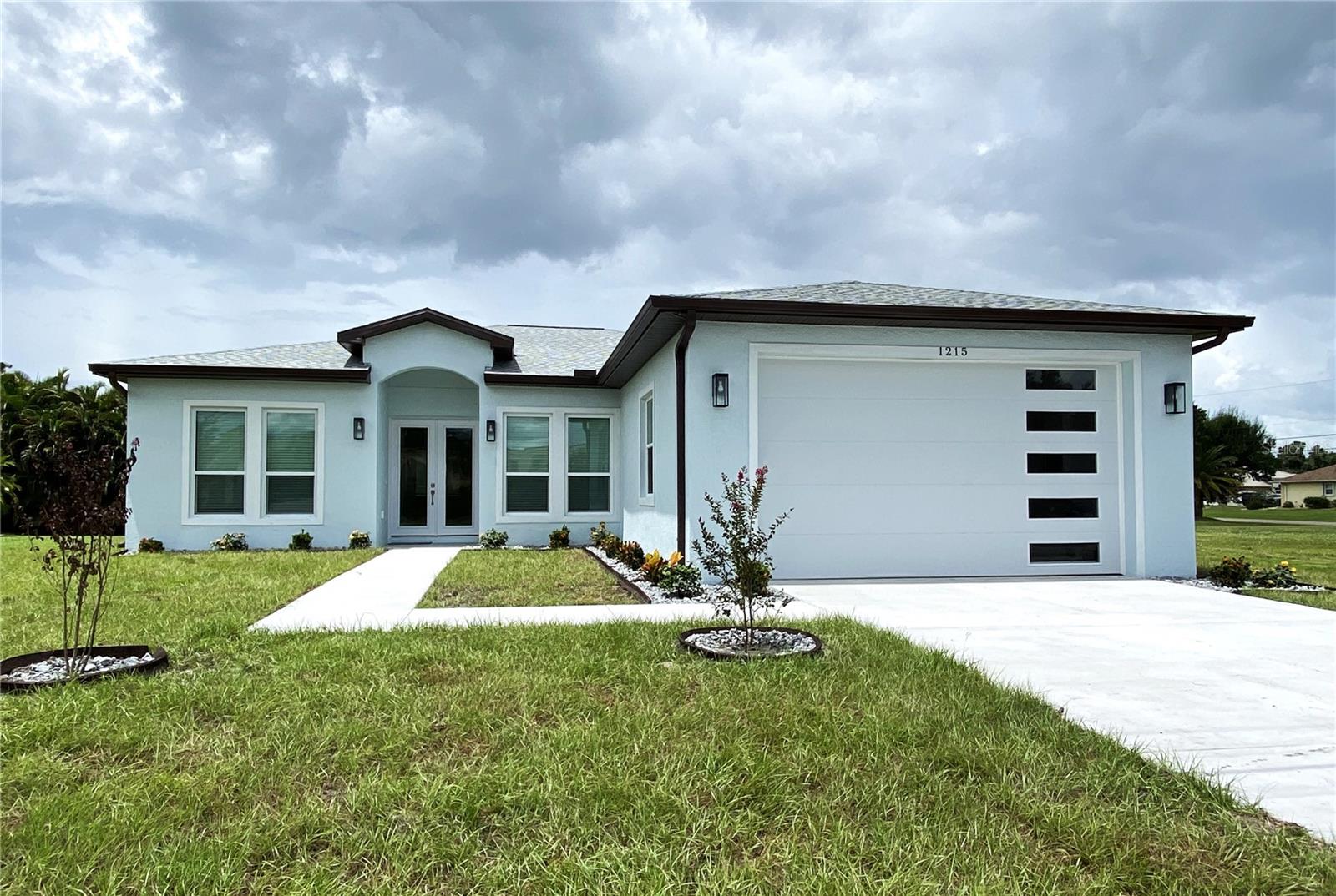 BRAND NEW stunner in Deep Creek! Why wait months for your new home to be built, when THIS beauty is completed and ready for new owners! Built in 2025, this 3 bedroom, 3 bath home has 2,214 sqft under air. Concrete block construction, on City Water & Sewer, not in the Flood Zone, and plenty of room for a pool! Soaring 10ft ceilings impress from the moment you enter, and the kitchen is a chef's delight! Wood cabinetry with soft close drawers, Quartz counter tops, marble backsplash, double lazy Susan in the corner cabinet, large closet pantry, and built-in electric cooktop. Stainless appliances include wall mounted oven & microwave, double door refrigerator, and dishwasher. Gorgeous free standing prep island has the same Quartz countertop, deep oversized stainless sink and additional storage. Three beautifully outfitted bathrooms with tiled showers, glass doors, porcelain tile, quarts counters with custom hardware, and an ultra modern soaker tub in the 2nd bathroom. Waterproof luxury vinyl flooring throughout the home. All windows & front door are Hurricane Impact Rated, so no need for shutters! 50 gal hot water tank, 3 ton 16 SEER AC with RETURNS in all bedrooms. Custom lighting(inside & outside) & fan package, 8 ft doors, recessed can lighting in living areas, undermount sinks, pull-down faucet in kitchen, hand finished drywall coating, 5" base moulding, shining epoxy painted garage floor, 200 amp service, and well lit & landscaped front entry along the sidewalk as you approach the front of the home. This home is ready for distinctive owners to begin their exciting new Florida lifestyle! Make your appointment today!