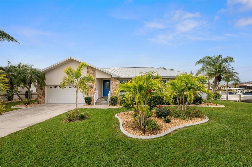 OVERSIZED TIP LOT!! Boasting 168 ft of CANAL FRONTAGE and a 10 minute boat ride to Charlotte Harbor, this stunning Punta Gorda Isles home is a relaxing tropical oasis! Nestled in the sailboat section of PGI, this gorgeous COMPLETELY REMODELED 3 bed 2 bath POOL home sits on a quiet cul-de-sac with quick access to open water through Ponce Inlet or Buckley’s Pass. A NEW METAL ROOF (2023), NEW hurricane impact windows and sliders, irrigation system, lanai & landscape lighting, cement landscaping borders, variable speed pool pump and a 10,000 lb. boat lift are just a few exterior features of this waterfront gem. Throughout the new open floor plan are wood look tile floors, 5 panel solid core doors, 5 inch baseboards, recessed lighting, Bali window treatments, and fresh paint. The spacious, open-concept kitchen is equipped with soft close cabinets, quartz countertops, LG appliances, Zephyr range hood, granite composite sink and an oversized island. The master suite features a large walk-in closet, new glass door walk-in shower and separate vanity. This split bedroom interior is perfect for privacy and entertaining. The two guest bedrooms include walk-in closets next to the guest bathroom with convenient lanai and pool access. A brick paved lanai offers an ideal outdoor living space including a 15’ x 30’ heated freshwater pool overlooking a breathtaking view of the water! Garage updates include epoxy floors, cabinets and work station, ceiling storage rack and fresh paint. Only a short ride to historic downtown Punta Gorda, Fisherman’s village, golfing, shopping, fine dining, beautiful parks, and access to world class fishing and boating, this home is truly a Floridian paradise! Schedule a showing today!
