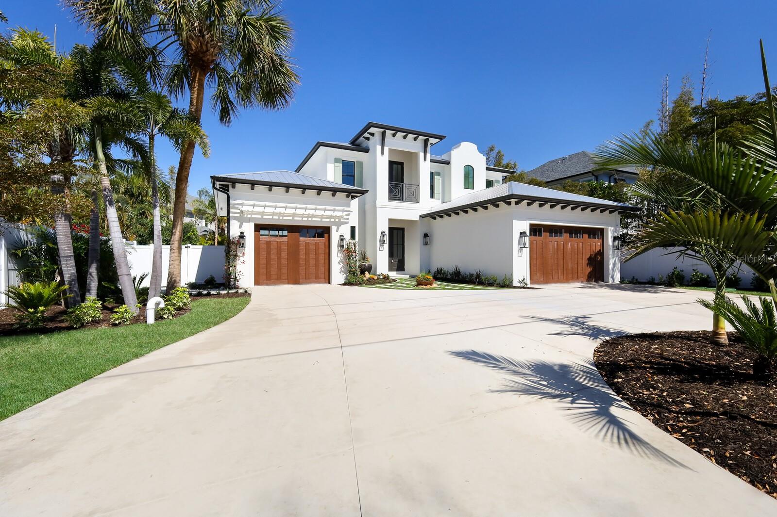WEST INDIES STUNNING CUSTOM POOL HOME WEST OF THE TRAIL! Introducing an exquisite, just completed (2024) residence that epitomizes luxury living at its finest. BUILT TO THE HIGHEST STANDARDS INCLUDING ALL HURRICANE IMPACT WINDOWS AND DOORS. This professionally designed 4 bedroom 4.5 bathroom home boasts amazing architecture, gorgeous metal roof, a charming half-circle driveway with a three-car garage, all framed by immaculate landscaping and artificial turf highlights for effortless curb appeal. Step inside and be greeted by the timeless elegance of wood floors throughout, complemented by an inviting electric fireplace adorned with shiplap accents. The spacious great room layout is accentuated by expansive sliding doors, allowing for seamless indoor-outdoor transitions and flooding the home with natural light. The floor plan is just what buyers are looking for....open design, split bedrooms with the master downstairs and multiple living areas! The master suite is a true sanctuary, offering a private escape with double walk-in closets featuring custom closet systems, transom lighting, and sliders leading to outdoor tranquility. The ensuite master bath is a haven of relaxation, featuring exquisite flooring, double vanities, large walk-in showers, and a luxurious soaking tub. Every detail of this home exudes quality craftsmanship, from the solid wood doors to the crown molding and large baseboards that adorn each room. The chef-inspired kitchen is a culinary masterpiece, featuring a massive island with quartz countertops, pendant lighting, wood cabinets with crown molding, double ovens, a stunning hood, and a herringbone tile backsplash. A butler's pantry with a microwave, wine refrigerator, and sink adds convenience, while the adjacent laundry room offers practicality with a sink and cabinets. Upstairs, you'll find three additional bedrooms, two baths, and a versatile bonus room, providing ample space for guests or relaxation. Outside, the tropical paradise continues with a travertine pool deck, a spacious covered patio, and a huge oversized pool surrounded by lush landscaping and a fence around the property, creating a private retreat for outdoor enjoyment. Additional full pool bath adds to this well thought out floor plan! This exceptional home offers the perfect blend of luxury, comfort, and style, providing a truly unparalleled living experience. Everything about this location is ideal...A rated school district! Minutes to shopping and restaurants! Minutes to the Siesta Key beaches! Around the corner from Red Rock Park and the highly desired Field Club! YOU SIMPLY WILL NOT FIND A BRAND NEW HOME WEST OF THE TRAIL WITH ALL OF THESE AMENITIES AT A BETTER PRICE!!! Come and experience the epitome of sophistication in this remarkable West Indies-style masterpiece!