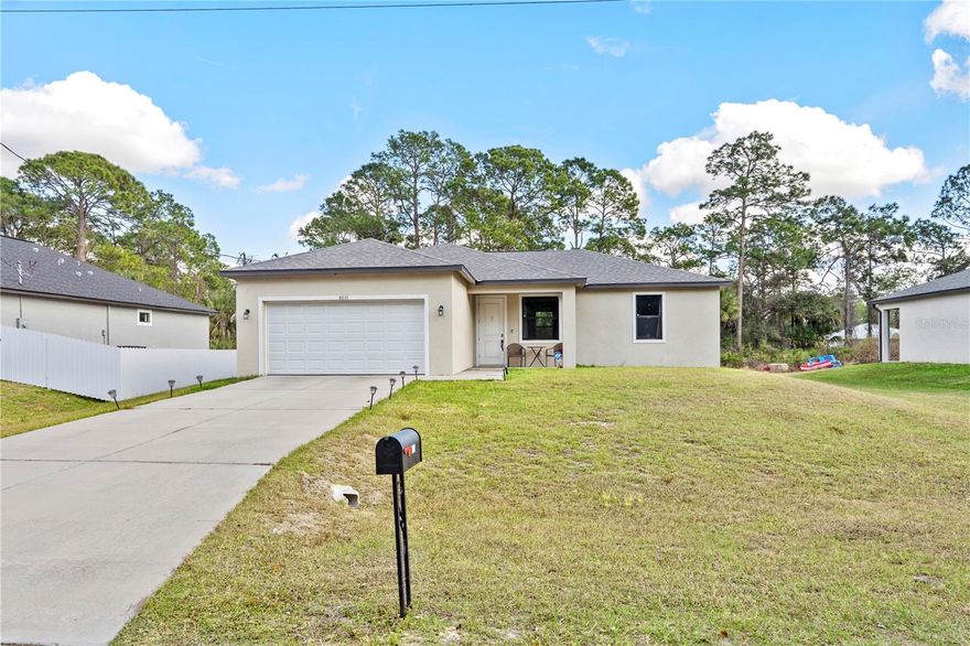 This beautiful 3-bedroom, 2-bathroom home, built in 2022, is located in the growing community of LaBelle, Florida, and sits on a spacious ¼-acre lot with a 2-car garage. Designed with comfort and style in mind, the property features an open-concept kitchen with elegant high-gloss white cabinetry, stainless steel appliances, and granite countertops, seamlessly flowing into the main living areas. The home offers waterproof laminate flooring throughout, thoughtfully selected to complement the granite surfaces and neutral wall colors. Both bathrooms are fully tiled and feature modern vanities with granite countertops and refined finishes. High ceilings throughout the property enhance the sense of space and natural light, while impact-resistant windows and doors provide added security and energy efficiency. As a newer construction, this home offers long-life systems and the benefit of more affordable property insurance. Additional features include a complete ADT security system with cameras and door and window alarms, a washer and dryer, and partial furnishings, including a living room set, dining table, sofa, and more—all included in the sale. This move-in-ready home combines modern design, quality construction, and valuable upgrades, making it an excellent opportunity for homeowners or investors alike.