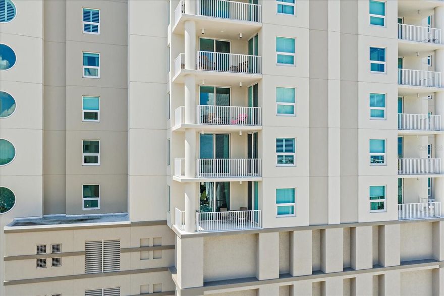 One or more photo(s) has been virtually staged. Rivo at Ringling rises as a beacon of contemporary sophistication in downtown Sarasota—a 16-story architectural statement completed in 2006 that artfully balances modern design with serene urban living. Encompassing just 106 private residences encircling a dramatic, light-filled atrium, it feels more like an exclusive vertical sanctuary than a downtown condominium.

Within this coveted address, Residence #703 has been meticulously redesigned and refined to capture the essence of effortless luxury. The 2-bedroom, 2-bath layout—complemented by a custom, flexible-use den—embodies both artistry and functionality. The chef’s kitchen gleams with bespoke, stacked cabinetry painted to accentuate height and light, while quartz surfaces flow seamlessly into a full-height backsplash that reads more as sculpture than surface. Stainless steel appliances and designer lighting complete the composition, setting an elegant tone that continues throughout the open living and dining space.

Expanses of glass invite the outdoors in, framing the city skyline and drawing the eye to an oversized, north-facing 20×9-foot terrace—an alfresco retreat ideal for morning espresso or evening reflections, where Sarasota Bay glimmers faintly on the horizon.

The primary suite extends an aura of quiet indulgence. Its spa-inspired ensuite showcases a frameless glass shower, couture tilework, custom cabinetry, and statement lighting that transforms routine into ritual. Plantation shutters filter the Florida sunlight, while direct terrace access and a well-appointed walk-in closet complete the tranquil scene.

A split-bedroom layout ensures privacy for guests, while the generous den serves equally well as a study, media lounge, or third sleeping space—ideal for those balancing leisure and productivity. The secondary bath, with its elevated finishes and artful detailing, reinforces the home’s cohesive sense of design. Both bedroom sets convey with the sale.

Practical touches underscore the thoughtful craftsmanship throughout: a separate, exterior AC handler closet maximizes interior peace and utility, enhanced with a UV light system to promote cleaner air and additional storage for travel essentials.

Beyond the residence itself, Rivo at Ringling distinguishes itself with offerings rarely found in downtown living: two oversized, under-building parking spaces within a gated garage, a private storage room, secure bike and kayak storage, and convenient EV charging stations.

The amenity collection evokes the feel of an intimate resort—concierge services, a heated pool and spa with sun deck, a covered grill terrace, a state-of-the-art fitness center, and sophisticated social lounges. A fully funded reserve, flexible rental policy, and pet-friendly ethos enhance both livability and long-term value, while dedicated on-site management ensures a seamless experience.

Step outside and Sarasota’s cultural heartbeat unfolds within moments—acclaimed dining, the opera, theaters, live music, art galleries, and the Bayfront promenade, all effortlessly accessible.

For the discerning buyer who values artistry in both design and lifestyle, Residence #703 delivers a rare balance of elevated interiors, turnkey convenience, and a quintessential downtown address—complete with both bedrooms fully furnished for a move-in-ready transition.

At Rivo, sophistication meets serenity—a modern reprieve in the rhythm of the city.