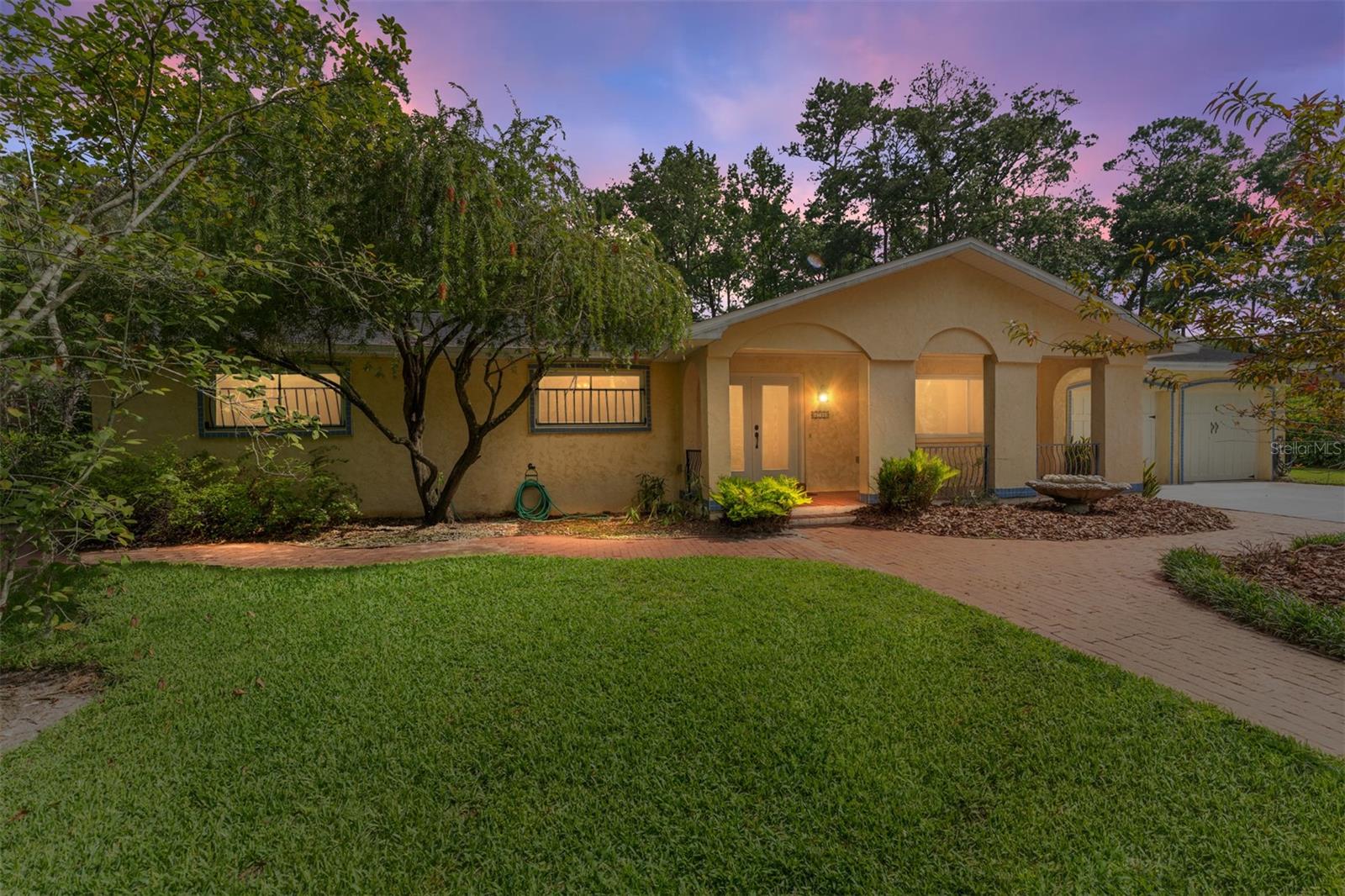 Welcome to Suburban Heights — One of Gainesville’s Most Beloved, Central Neighborhoods! Tucked away on a lush, oversized lot, this spacious 5-bedroom, 2-bath home offers timeless charm with thoughtful updates, all just minutes from everywhere you want to be—Shands Healthcare, The VA, the University of Florida, Downtown Gainesville, Butler Plaza, I-75, and 441—all within 15 minutes or less! And best of all, there’s no HOA to limit your plans or lifestyle. Welcome to this charming and spacious home offering a perfect blend of classic character and modern functionality. This home features a striking concrete stucco exterior with timeless arched architectural details and a welcoming covered front porch adorned with decorative wrought-iron railings, terra-cotta colored tile flooring, and Spanish-style tiling and arches that create a semi-private space. Lovingly cared for by the same family since it was built in 1974, it holds a special sense of history and pride of ownership, offering a rare opportunity to own a home that’s been cherished as a backdrop of memories and Gainesville traditions. It’s now ready for new owners to write their own story within its welcoming walls. Step inside to discover refinished parquet floors that radiate warmth and character, freshly painted interior walls in key spaces, modernized light fixtures blending beautifully with the home's original character, spa-like updated bathrooms, and double-insulated windows for energy efficiency and year-round comfort. The roof was replaced in 2021 and HVAC just had maintenance tune up in June ’25. The inviting layout includes a classic formal dining and living room in the front, complemented by two additional family rooms off the kitchen—ideal for creating separate spaces for casual gatherings, game nights, hobbies, or versatile living. A dinette area offers a cozy spot for everyday meals. The wood-burning fireplace in the family room is perfect for cool evenings, and the two updated bathrooms blend comfort with fresh, stylish finishes. Need extra space? You’ll appreciate the flexibility of 5 bedrooms—two of which are tucked away at the rear of the home, with a separate exterior entrance already in place. Whether you need space for guests, a home office, a studio, or a private retreat, these rooms offer endless possibilities. Outside, enjoy the best of Florida living with a spacious screened porch and a large brick-paved open patio—ideal for backyard barbecues, summer gatherings, or simply unwinding while overlooking the serene, private yard. The expansive yard is an absolute standout—your vision of adding a future pool, creating garden beds, or preserving the natural landscaping for privacy and shade, is endless. There’s ample space for weekend lawn games, autumn tailgate parties, sun-soaked afternoons, or simply enjoying the serene natural surroundings under the canopy of mature trees. Suburban Heights has long been sought after for its large lots, generously sized homes, and unbeatable central location—this home is the perfect blend of space, comfort, and convenience in one of Gainesville’s most coveted neighborhoods. This home offers all of that and more—an incredible chance to own a spacious, well-maintained home with older charm, thoughtful updates, and room to thrive in one of Gainesville’s most sought-after communities. Don’t miss your opportunity to own this one-of-a-kind home with space, character, and an address that puts everything at your doorstep.
