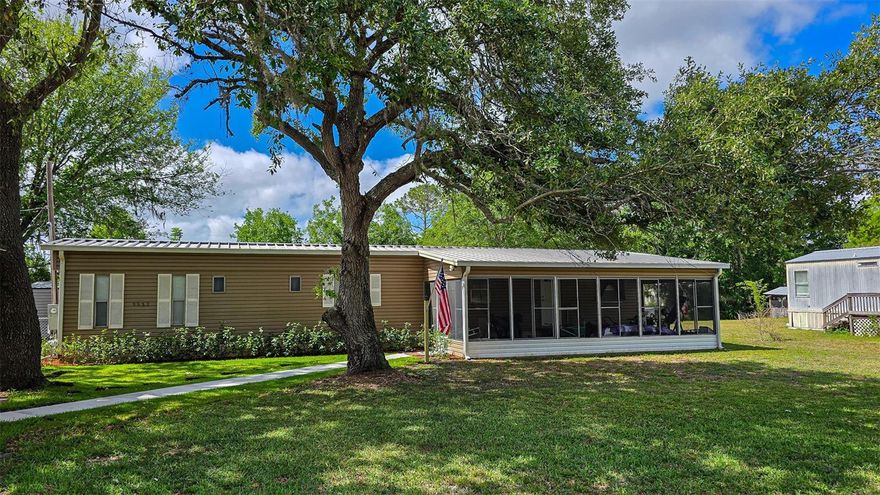 Honey, stop the car!! Check out this waterfront, furnished mobile home on a canal that leads right out to the lake!! Fishermen's dream home!! Nice, oversized screened room on the front. Lots of recent upgrades, including the kitchen cabinets, countertops and stainless appliances. Both bathrooms have been updated all the way around!! The inside has fresh paint, window blinds, vinyl flooring, baseboards, moldings, interior doors, electrical outlets and more!! The outside has a new HVAC system (2024), chain link fencing, new deck, new well pump and water filter system, upgraded plumbing (pvc) and a new storage building. The driveway has been paved and a carport added. It is move in ready!! Bring your suitcase and make yourself at home!!