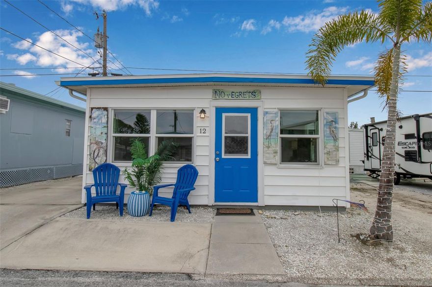 Own a unique piece of Florida history in the heart of Paradise Bay! This "cute as a button" cottage is the only stick-built home in the community and famously served as the summer retreat for a Barnum & Bailey circus performer. Featuring extraordinary curb appeal with custom-painted shutters by a local artist, this home perfectly blends vintage charm with modern, move-in-ready updates.
The interior boasts an airy open-concept layout with 8-foot ceilings, coastal pastel tones, and crisp white wainscoting. The decorative epoxy-coated cement floors are as beautiful as they are easy to maintain. The efficient kitchen features white upper cabinetry and stainless steel fixtures, while the bathroom offers a walk-in shower with sliding doors and a dedicated laundry closet (hookups ready for an apartment-size stackable).
Recent upgrades include: 2025-New bathroom sink/cabinet, hot water heater, ceiling fans, and stainless fixtures. 2024-New decorative epoxy floor coating. 2023-New 8x5 aluminum storage shed. Extras: Off-street parking for 2 cars and approval in place for an unattached front deck.
Live the Resort Lifestyle: Paradise Bay Estates Co-Op is a premier 55+ waterfront co-op currently undergoing a vibrant transformation with numerous new homes and a soon-to-be-renovated Recreation Hall. Residents enjoy a massive heated pool and spa, fitness center, library, and a unique community woodworking shop. Stay active with pickleball, shuffleboard, bocce, and cornhole tournaments, or enjoy a sunset at the waterfront gazebos. For water lovers, the community offers a private boat ramp and a 97-slip marina (slips available via waitlist). All this is located just minutes from the world-class beaches of Anna Maria Island and historic Cortez Village. Numerous shops and restaurants are minutes away! Sold "As-Is." Don't miss this extraordinary coastal opportunity!