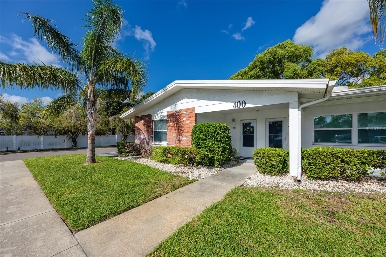 Welcome Home to the 1st floor corner unit villa at Bay East Condo with assigned and visitor parking in front & side of the building, high and dry, in a non-flood zone of Pinellas County. The property offers 1,000 sq. ft of living space with a primary bedroom featuring an ensuite bathroom and walk-in closet, a second bedroom, hallway bathroom, and a combined dining/living area. The updated kitchen includes new cabinets, solid countertops and extends into an enclosed back porch area, with two access points—front and back entrances. Recent updates include fresh paint, removal of popcorn ceiling, and installation of vinyl laminate flooring throughout the unit, updated bathrooms as well as brand new AC system and water heater. Bay East Three Condo is open to residents of all ages, allows pets, and provides a community pool and clubhouse. The location is approximately 20 minutes from the beaches, and close to shopping, restaurants, parks, and a community center. Schedule your showing today!