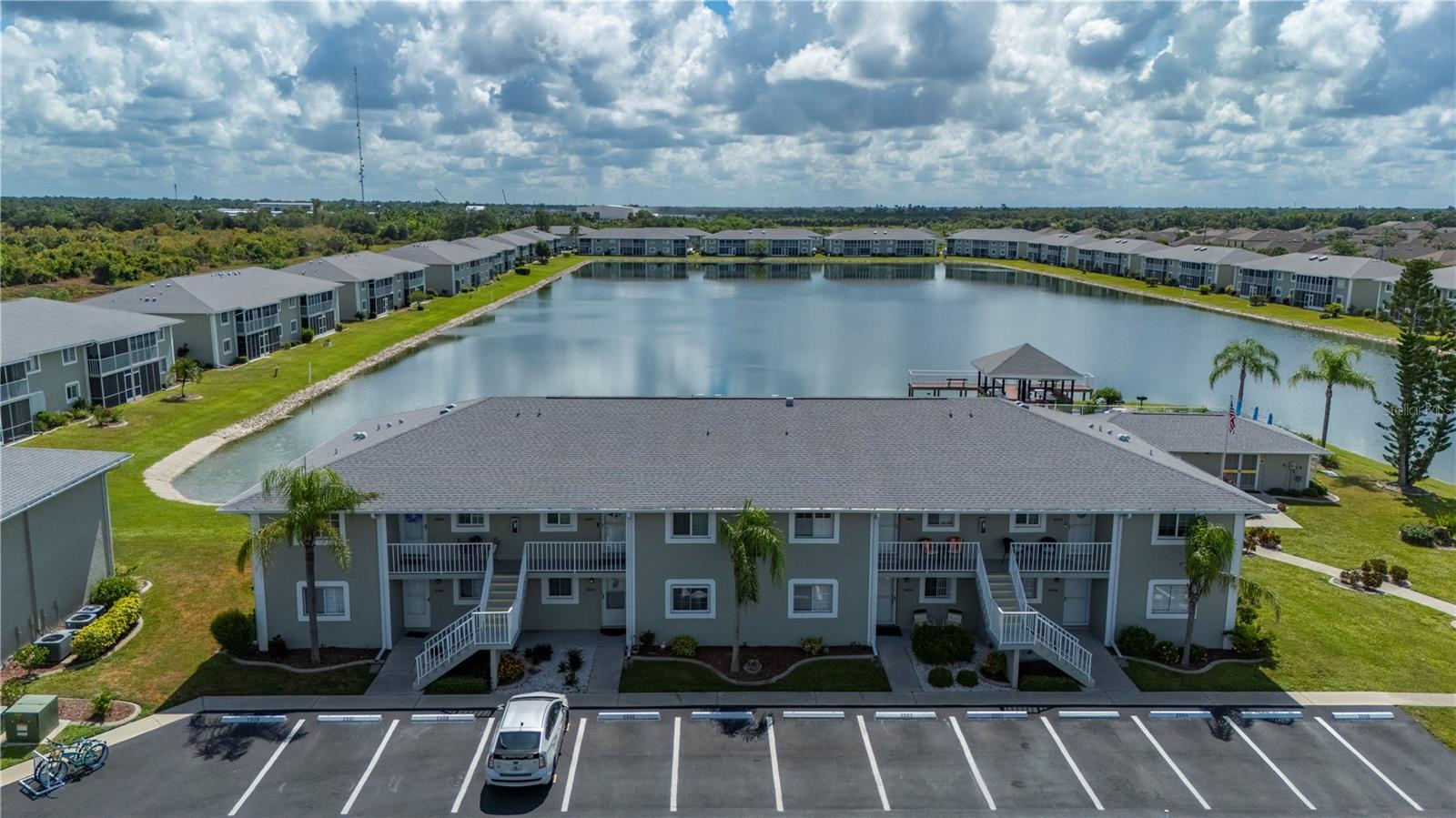Stunning Lakeview Condo in Sought-After Lakes Edge Community. Welcome to this ground-floor condo located in the highly desirable Lakes Edge community! This furnished unit offers a serene lifestyle with lake views and direct access to all the community’s amenities. Enjoy the Florida lifestyle from your private screened patio, perfect for morning coffee or evening relaxation while taking in the peaceful surroundings. The spacious and functional interior features a well-appointed kitchen with abundant cabinet space, comfortable-sized bedrooms, and an indoor utility/laundry room for added convenience. Take advantage of the ample living space, perfect for entertaining or simply enjoying the natural light and views that fill the home. The unit is move-in ready and ideal as a full-time residence or seasonal getaway. The Lakes Edge community boasts sidewalks for easy walkability, a community pool, clubhouse, private pier / dock, and professional management. Water is included, and the condo is centrally located between Port Charlotte and Downtown Punta Gorda, offering easy access to shopping, dining, and entertainment. Don’t miss your opportunity to own this beautiful lakefront condo—schedule your private showing today!