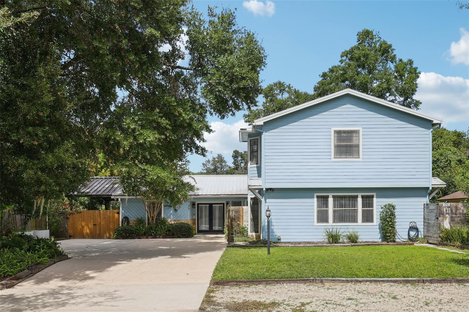 2 Homes in 1! Incredibly versatile and beautifully maintained single-family home located in the sought-after South St. Augustine community. Offering a total of four bedrooms and three bathrooms, this property stands out with a full accessory dwelling unit (ADU) turned guest house, ideal for use as an Airbnb or long-term rental. With no minimum lease term, no HOA, and no CDD, this home presents a rare opportunity to enjoy flexible living while generating passive income. The main house features three bedrooms and two bathrooms in a spacious and thoughtfully designed split floor plan. Upon entering, you are welcomed by a grand entry foyer that opens up to an expansive kitchen built for both entertaining and everyday living. The kitchen boasts ample island space, a floating center island, stainless steel appliances, a gas cooktop, and a true vented range hood. The home includes both a family room and a separate living room, providing plenty of space for relaxing or hosting guests. The primary bedroom is privately located away from the other bedrooms and features a walk-in closet and a beautifully appointed en-suite with a walk-in shower. One of the standout features of the main home is its flexibility. A hallway door can be locked to create a completely separate two-bedroom, one-bathroom suite, ideal for multi-generational living, guests, or even rental potential. The exterior offers a spacious back patio with a full deck, perfect for entertaining or enjoying quiet evenings outdoors. Additional highlights include a metal roof, great curb appeal, a private driveway, and two dedicated front parking spaces for guests. The guest house (ADU) adds tremendous value and versatility. It features a full kitchen on the first floor with all appliances conveying, and upstairs you'll find a massive open-concept bedroom and living area with a stunning bathroom and walk-in shower. This unit is connected to the main home via a partially converted mini garage space currently serving as a large storage closet. Whether you choose to host guests, rent it short-term, or use it as a private office or studio, the possibilities are endless. This property is a rare find in South St. Augustine, live in the main home while generating income from the guest house, or take advantage of the flexible layout for multiple living arrangements. South St. Augustine backs up to the ICW. Don't miss your chance to own this truly unique home!