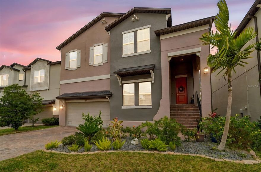 Welcome to this beautiful five-bedroom, four-bath single-family home built in 2020 and offering so much living space. Thoughtfully designed for modern living, the home features multiple gathering areas including a living room and a separate family room, each opening to its own balcony for indoor and outdoor enjoyment. The home is truly a split floorplan with a staircase leading you downstairs to the family room, 3 bedrooms, two full bathrooms, and one of the balconies. One of the bedrooms includes an en suite bathroom. Storage is abundant in this home. All of the closets include shelving systems and the space beneath the stairs has been turned into a very large closet. The second staircase leads you up into the kitchen, living room, primary bedroom, additional bedroom, full bathroom, laundry room, and second balcony. The kitchen is centered around a large island with integrated sink and breakfast bar seating, creating an efficient space for cooking and entertaining. A nearby dry bar with wine refrigerator provides additional storage and serving space. The large primary suite includes an en suite bath with water closet, linen closet and split vanities, along with two walk-in closets featuring built-in shelving systems.
Outdoor spaces extend the living experience with balconies designed for relaxation, including one equipped with a projector and screen for outdoor movie nights. The backyard features turf and an irrigation system creating a splash pad style water feature. Additional highlights include a spacious garage that accommodates large vehicles with additional storage. Located in a newer neighborhood with sidewalks and street lighting, the home offers convenient access to MacDill Air Force Base as well as quick access to St. Pete Beach and Downtown Tampa via nearby Gandy Blvd and the Selmon Expressway.