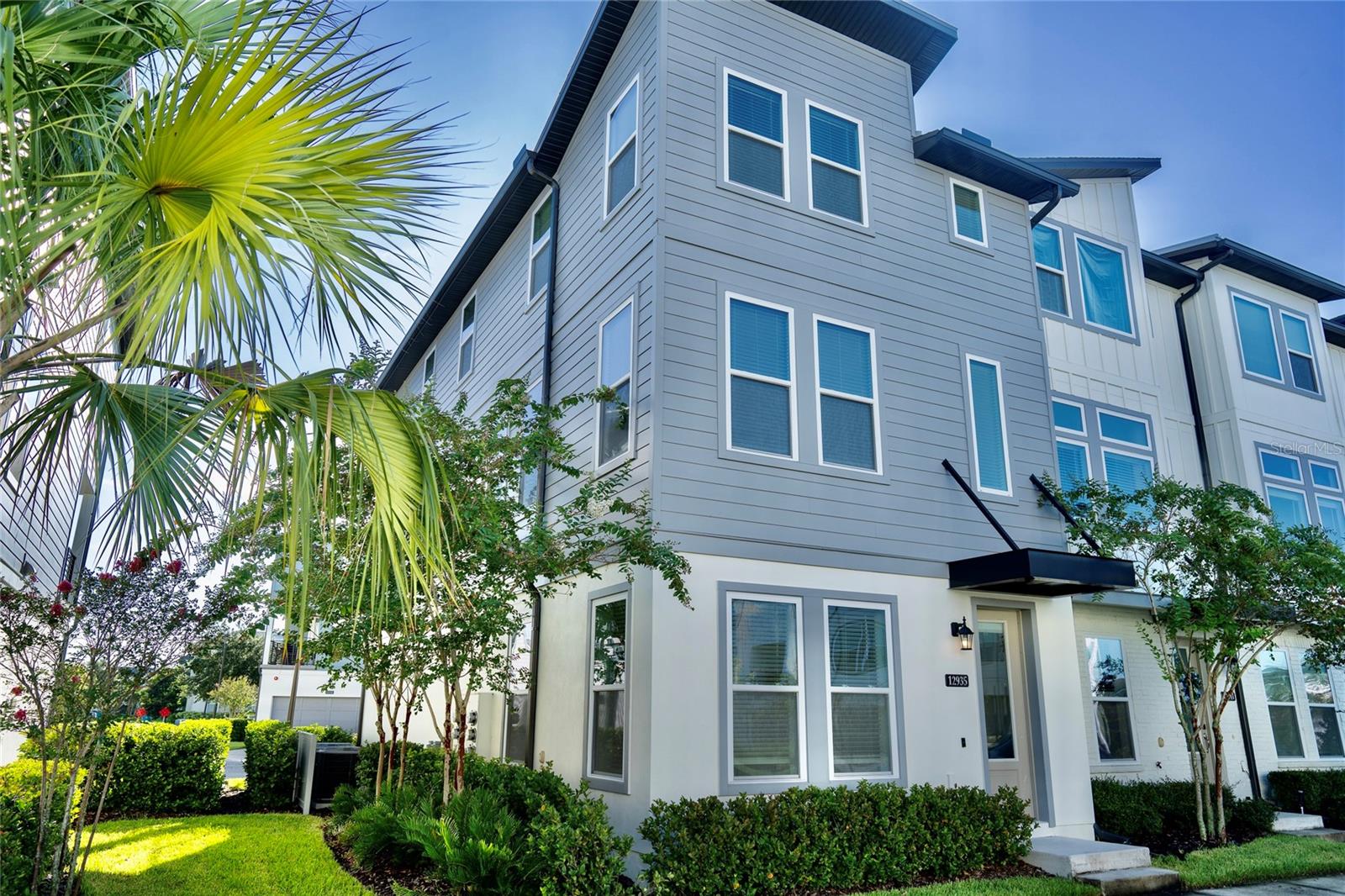Experience modern living in the heart of Laureate Park at Lake Nona with this stunning three-story townhome on Gabor Avenue. Designed with style and functionality in mind, the first floor offers a private bedroom and full bath—ideal for guests or a home office. The second level features an open-concept layout with soaring ceilings, abundant natural light, and a sleek modern kitchen that flows effortlessly into the dining and living areas. A private balcony extends the living space outdoors, perfect for enjoying morning coffee or evening sunsets. Upstairs, you’ll find two bedrooms, including the spacious primary suite with a walk-in closet and en-suite bath. Just steps from Canvas Restaurant & Market, and within close proximity to Laureate Park’s resort-style pool, fitness center, and community amenities, this home combines contemporary design with an unmatched Lake Nona lifestyle.